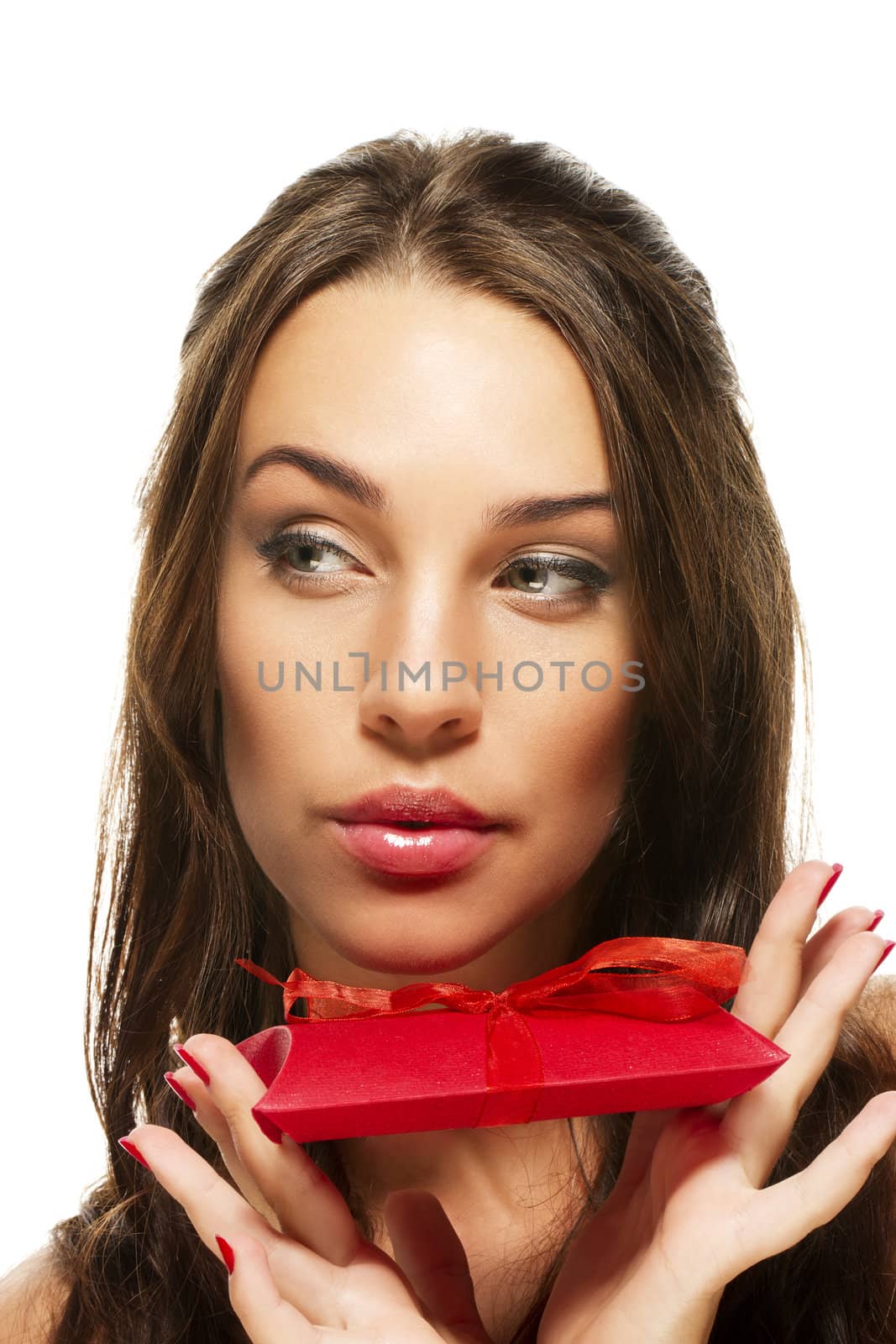 beautiful woman holding present looking to side on white background