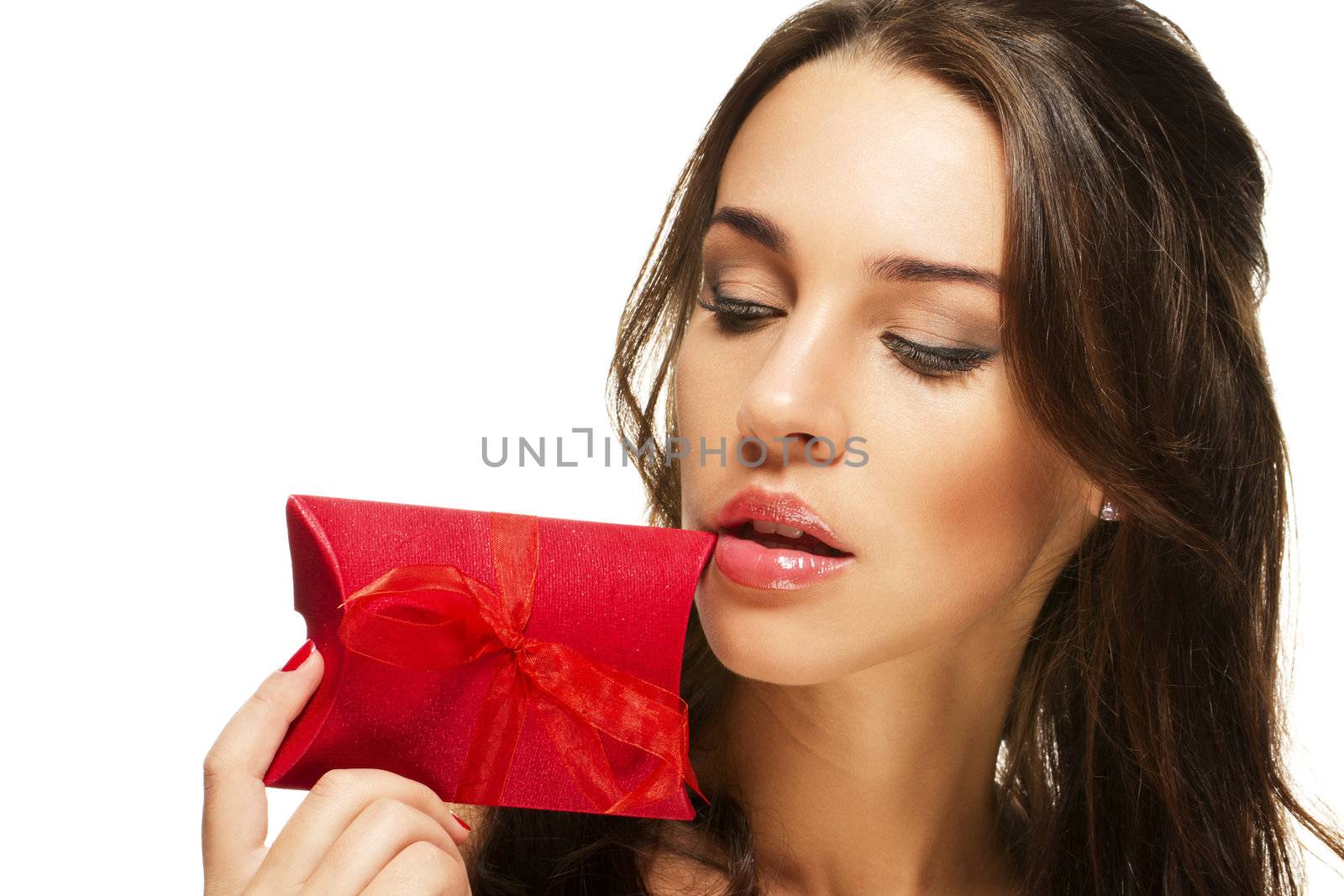 beautiful woman looking at the present near her face on white background