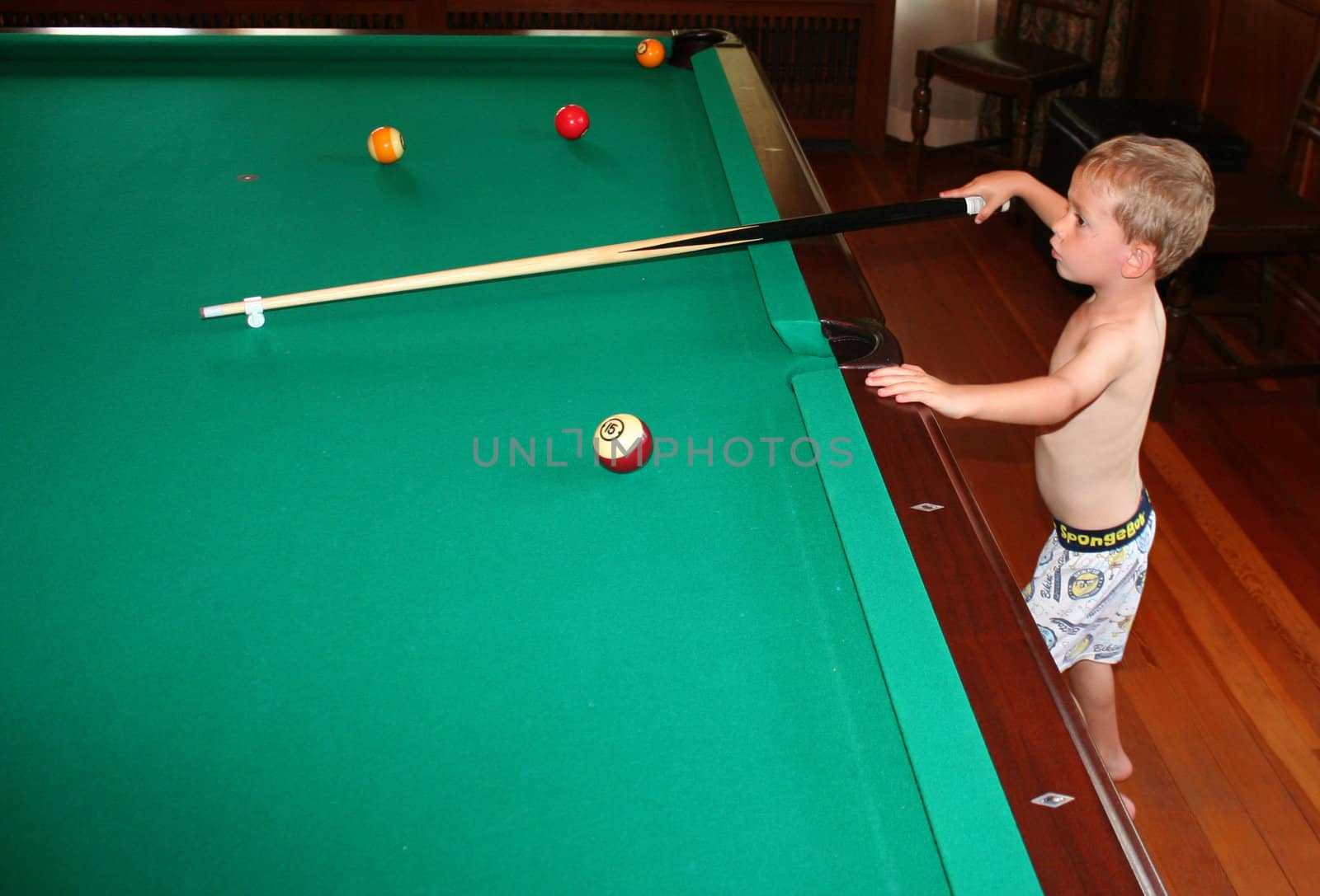 3 year old at pool table