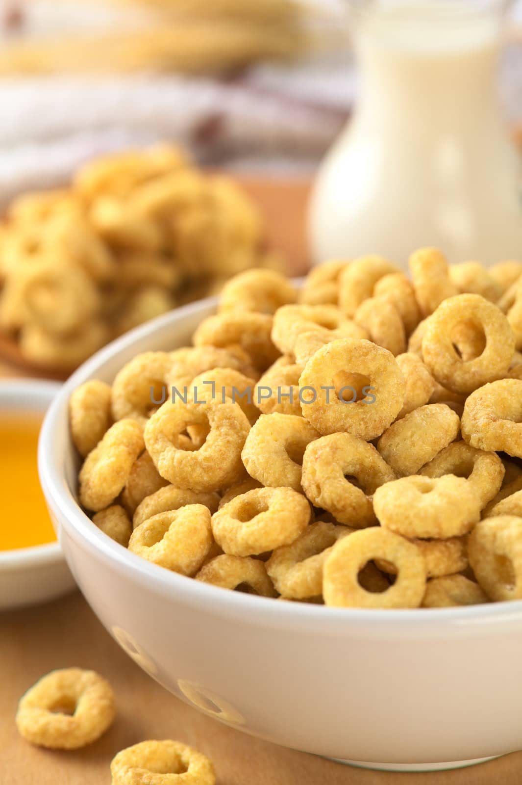 A bowl full of honey flavored cereal loops (Selective Focus, Focus on the standing cereal loop in the middle of the bowl)