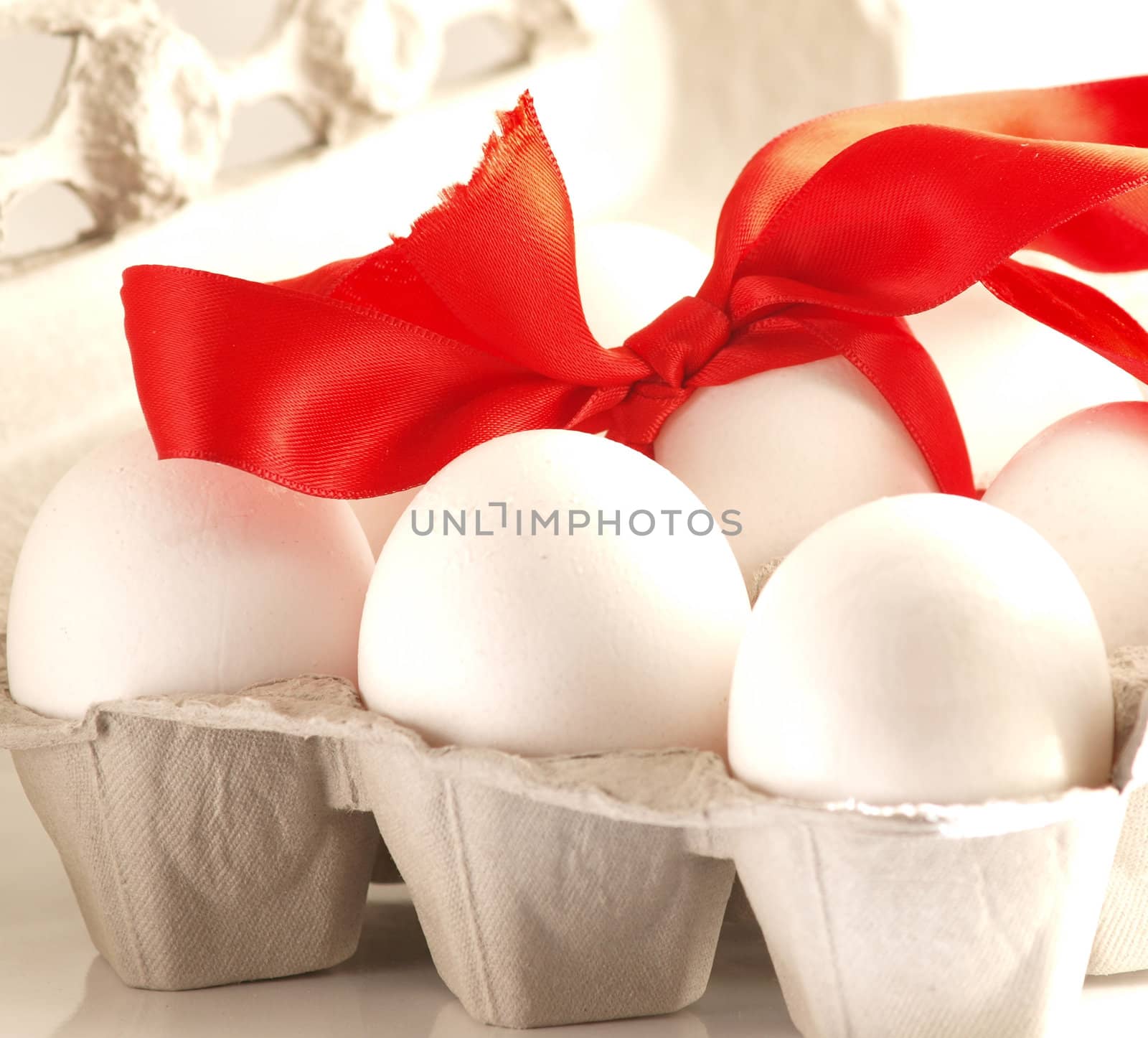 Eggs with a red ribbon, inside a egg frame