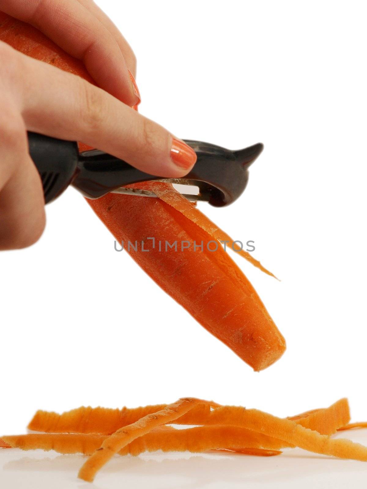 Woman pealing a carrot with matching nail polish, isolated towards white background