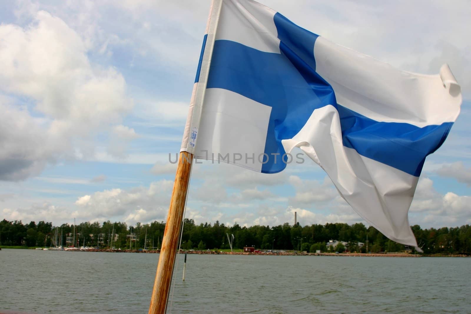 Finnish flag, on pole, at sea