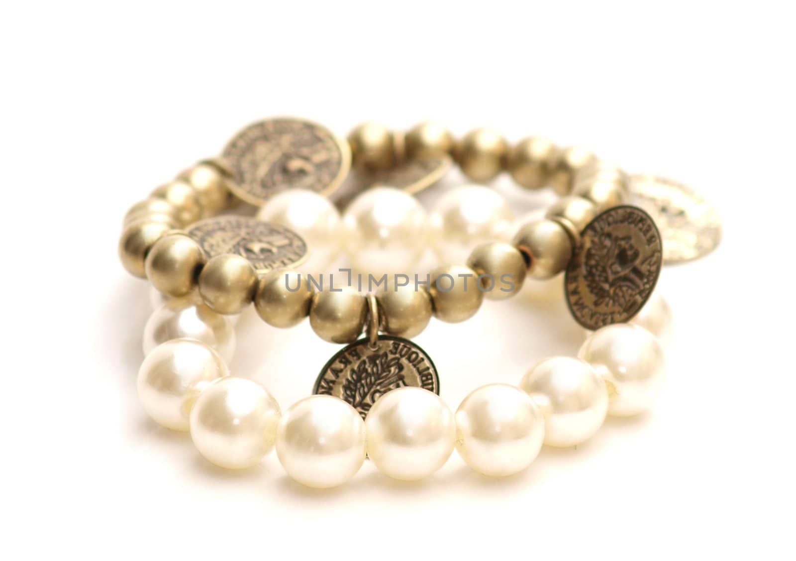 White and golden pearls with pennies, on white background 