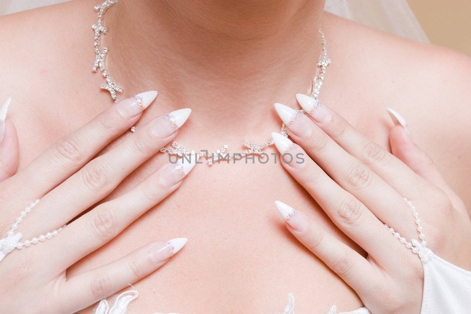hands of the girl on the necklace
