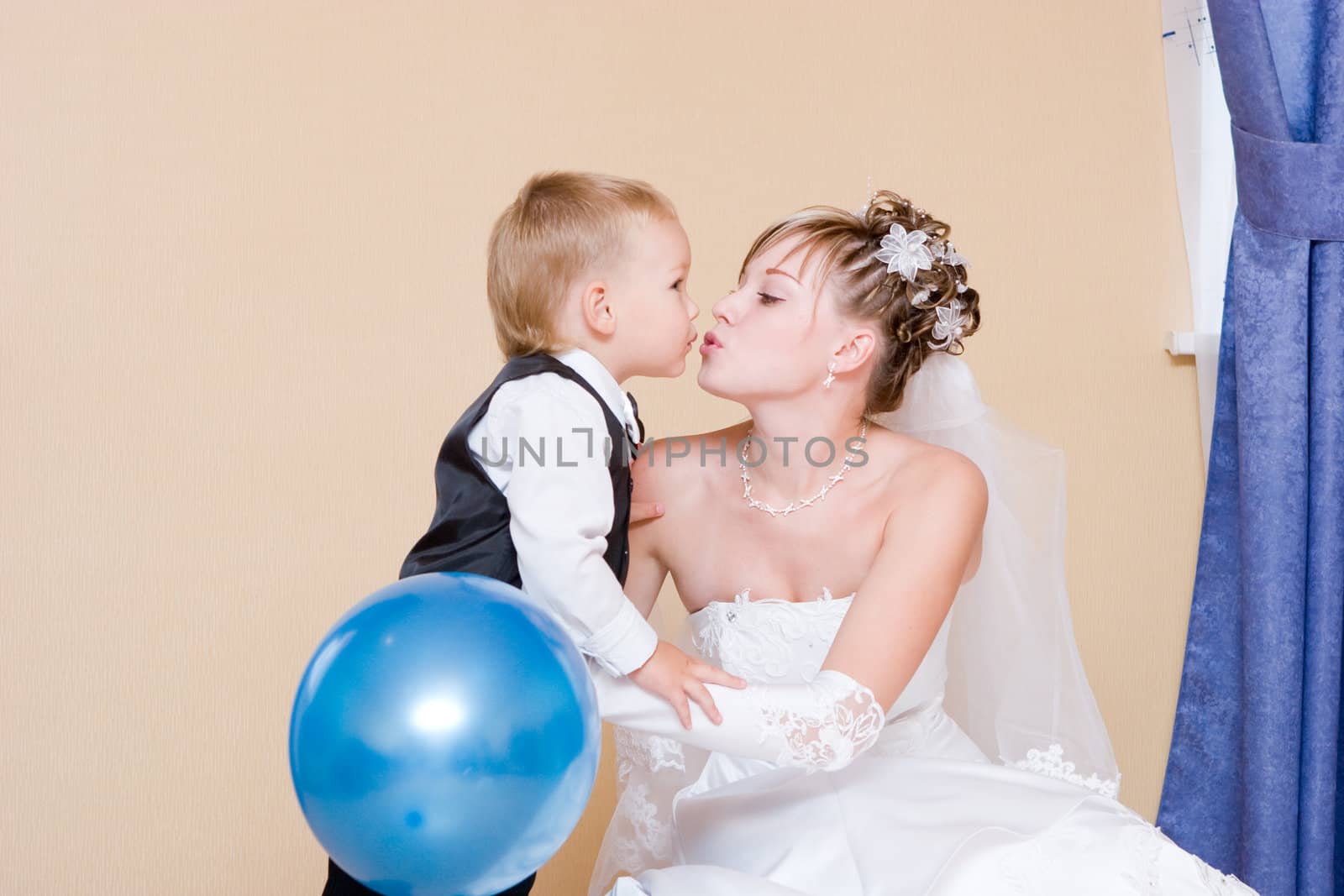 a bride and her li ttle brother of 3 years old kissing