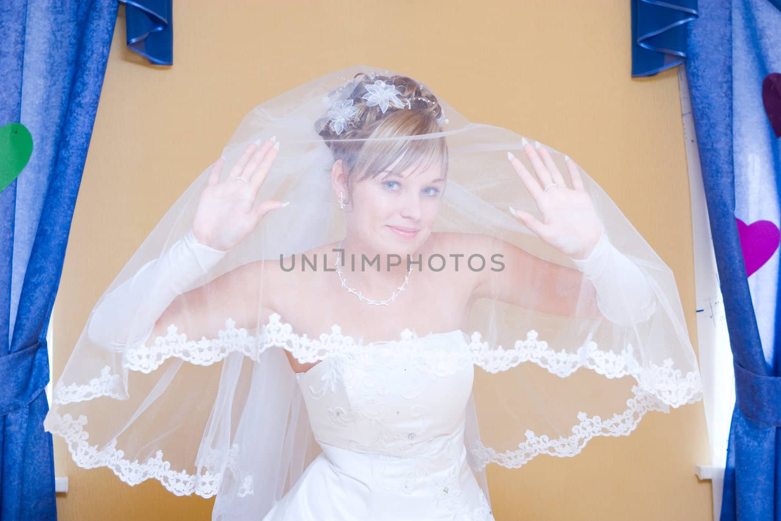 smiling bride looking from the veil