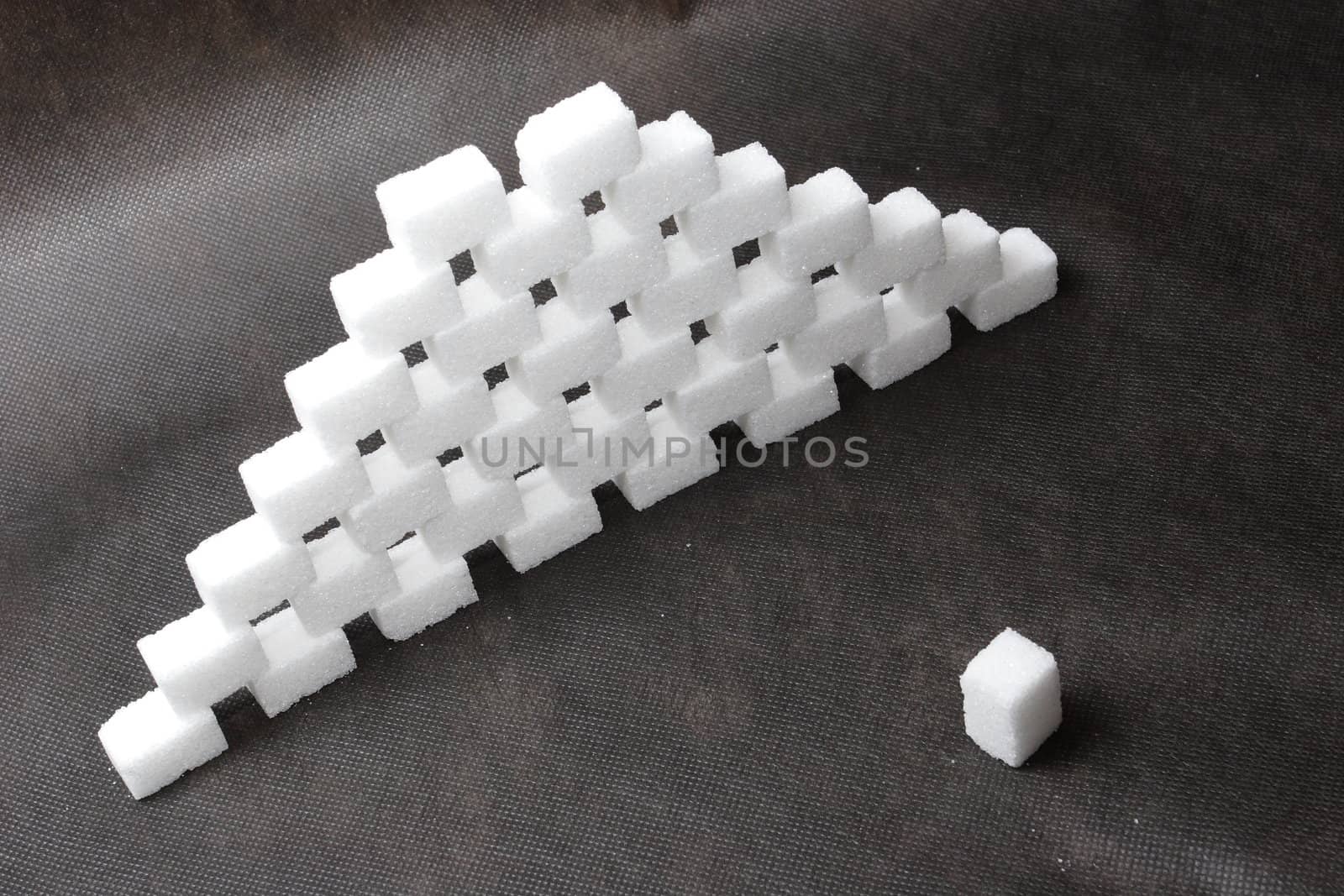 a wall of bricks of sugar on the black background