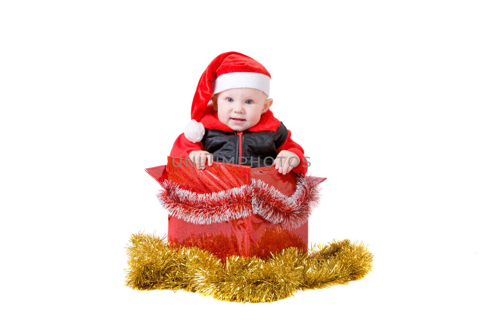 happy infant with red cap in a decorated christmas box