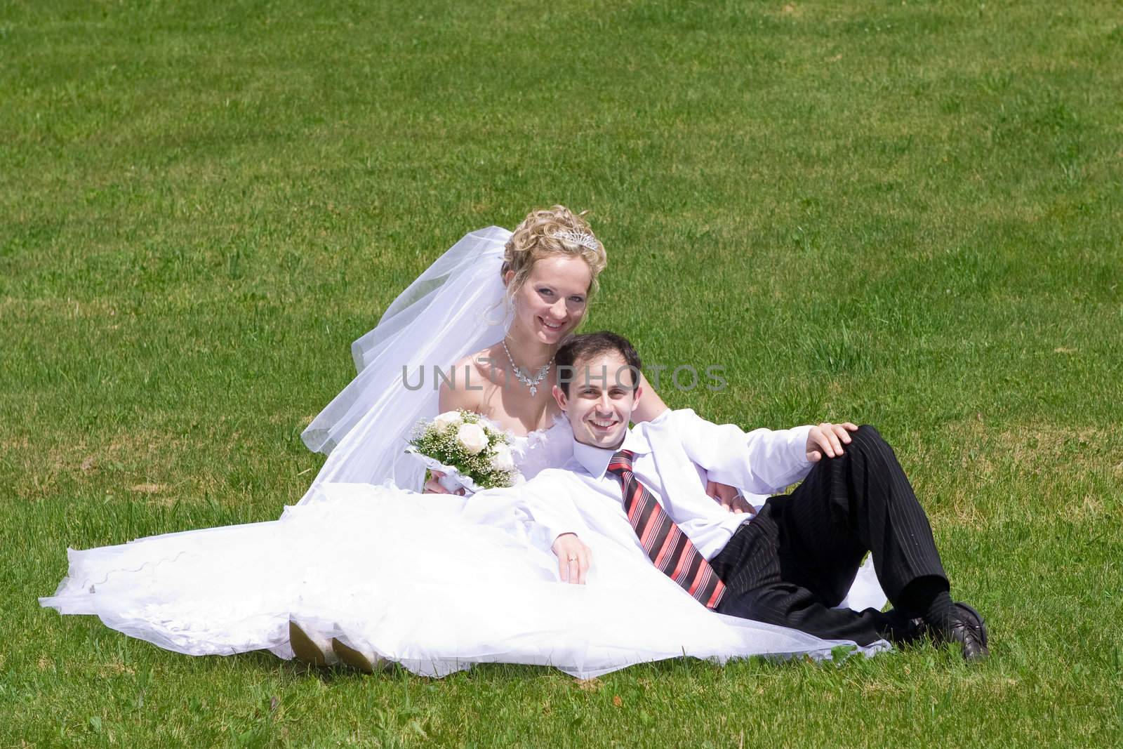 rest of the newly-married couple on the grass by vsurkov