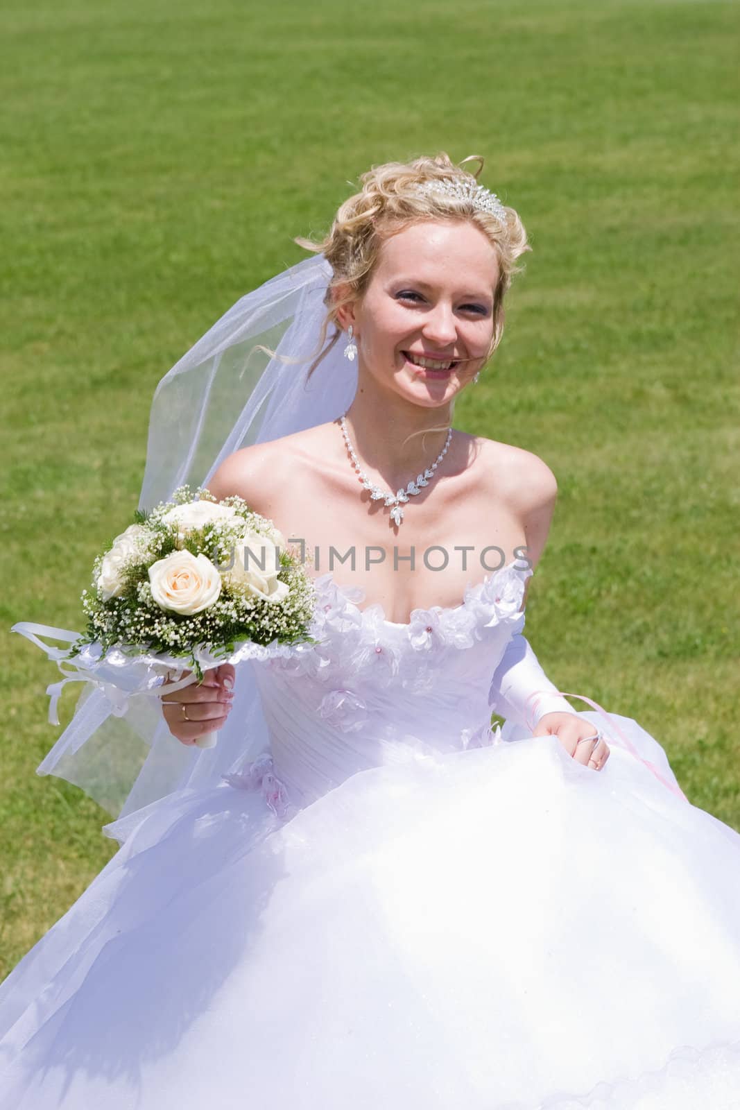 blond bride runs with bouquet of white roses