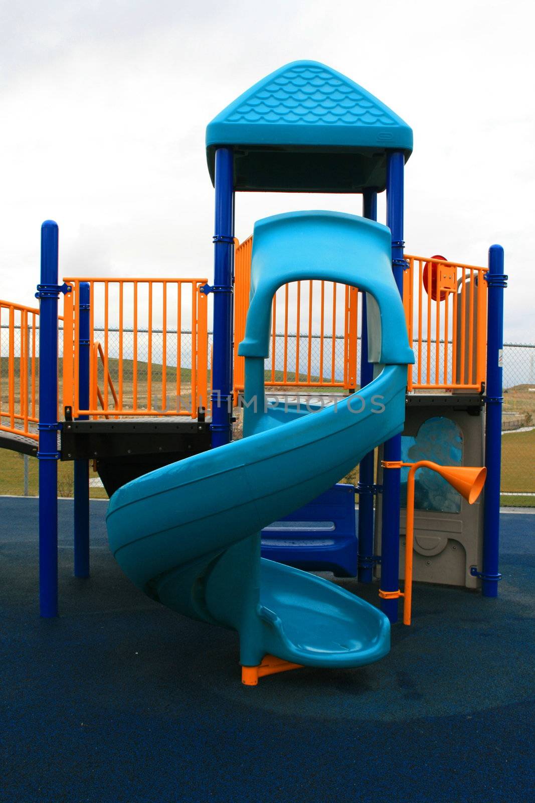 Blue slide in a school playground in a summer.
