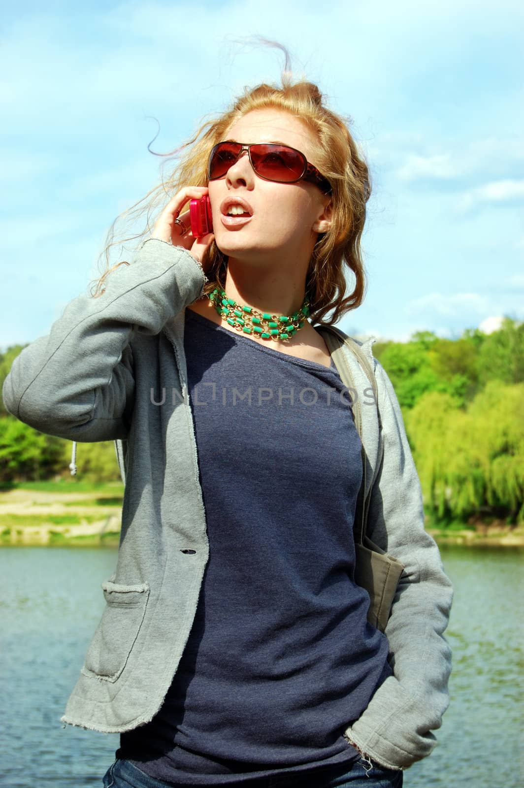 Girl talking on the phone on nature background