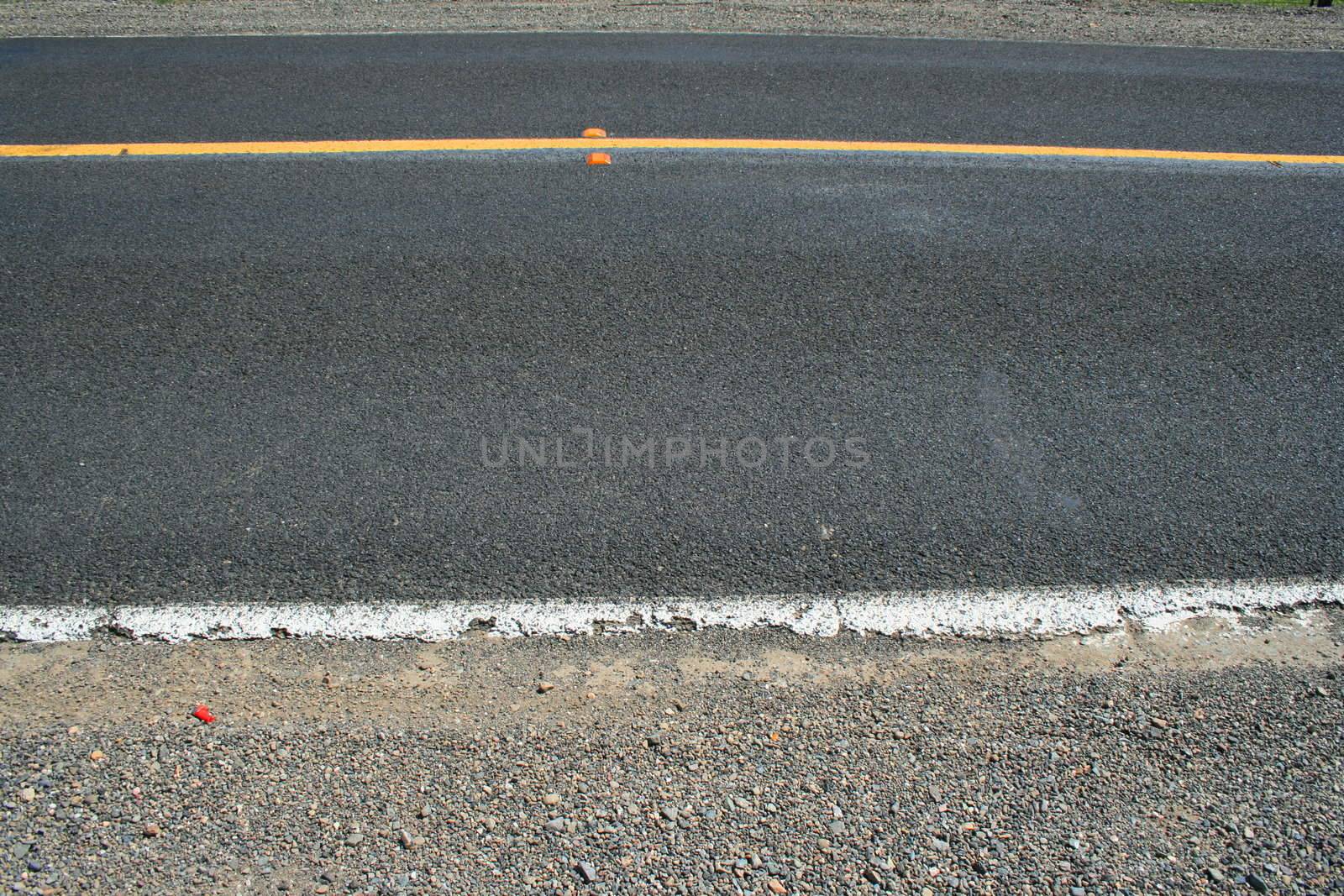 Close up of a road showing patterns.
