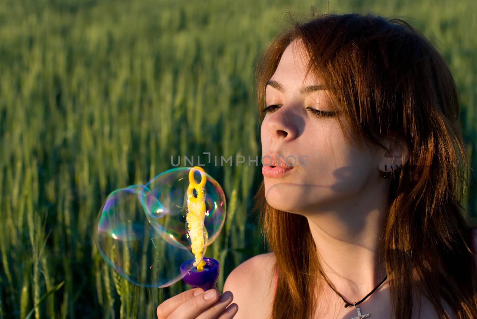A young woman blowing bubbles