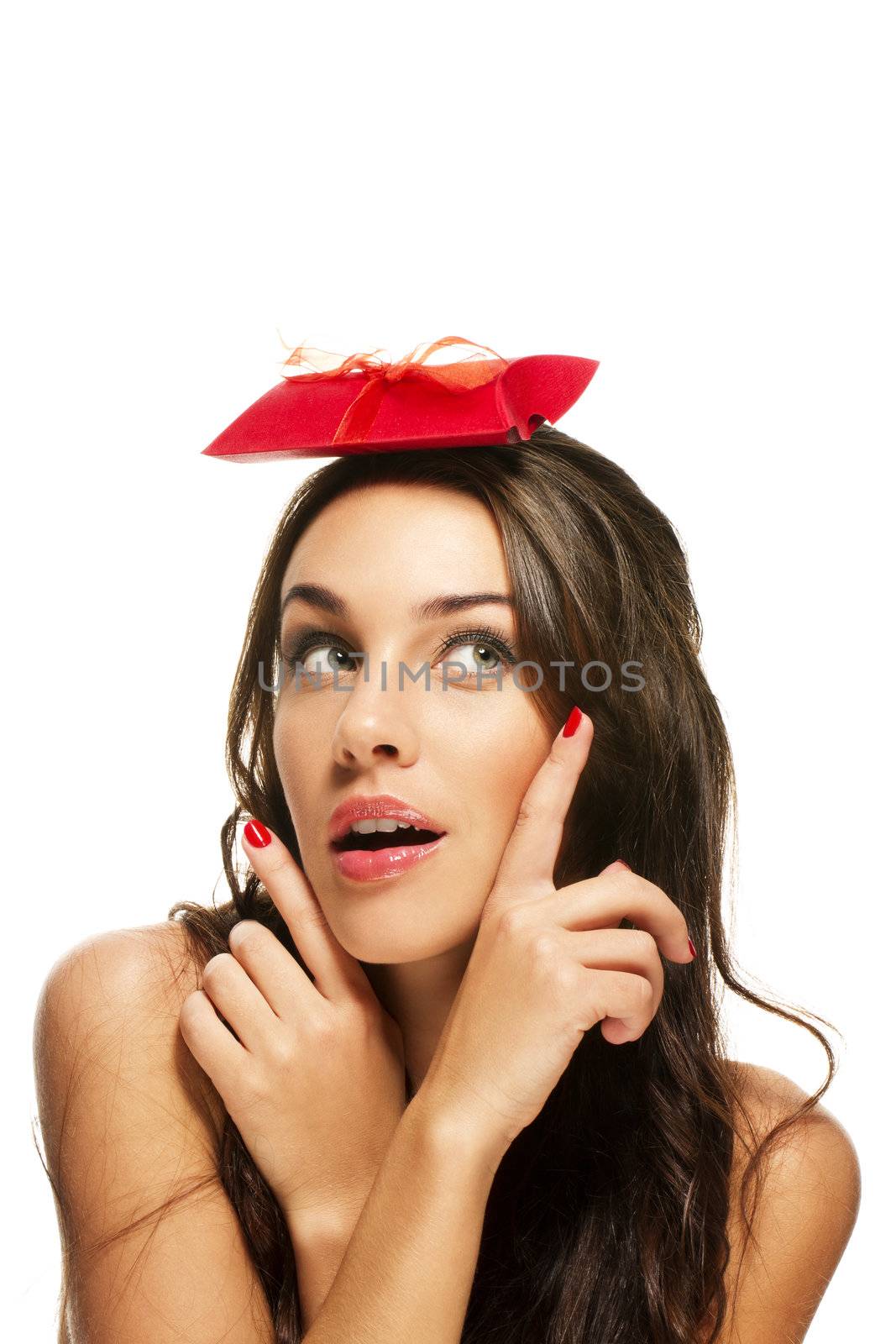 woman pointing with her fingers to the present on her head on white background