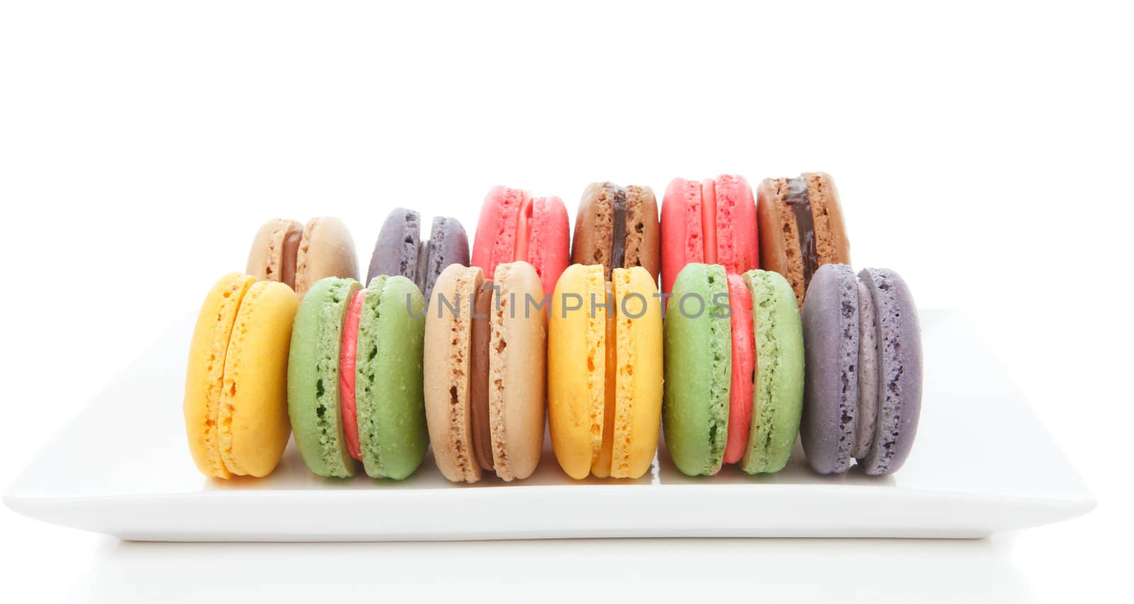 Delicious macaroons lined up on a plate.