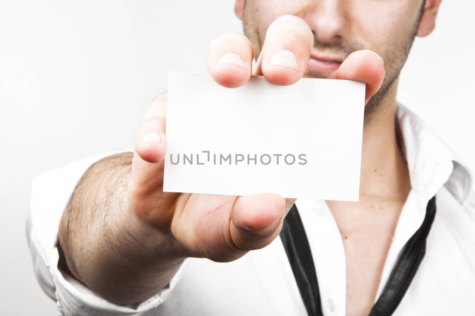 Image of a young and sexy business man showing his businesscard on white