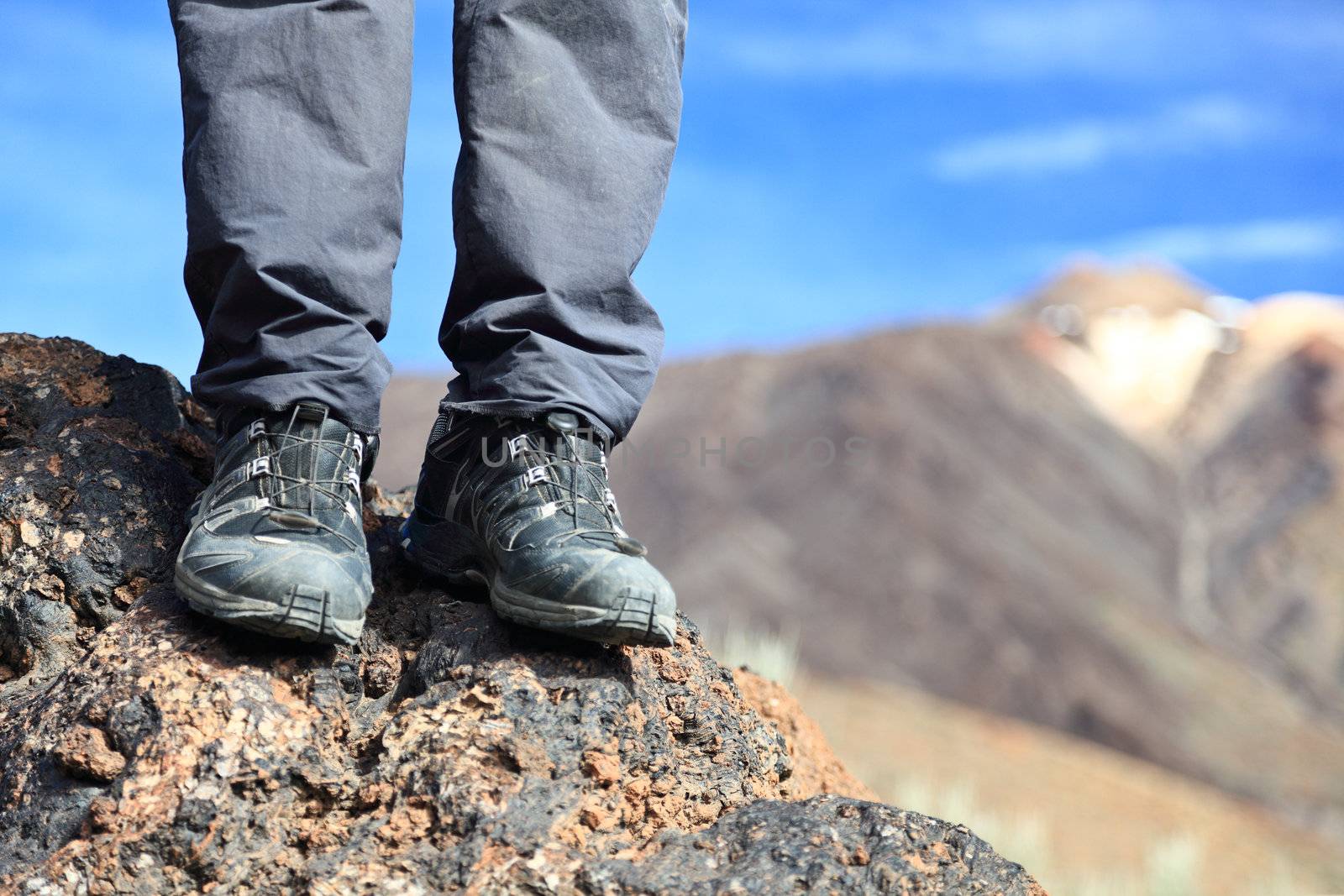 hiking boots / hiking shoes in mountain nature landscape. All year wear. Photo Tenerife, Canary Islands with mountain peak of volcano Teide in the background.