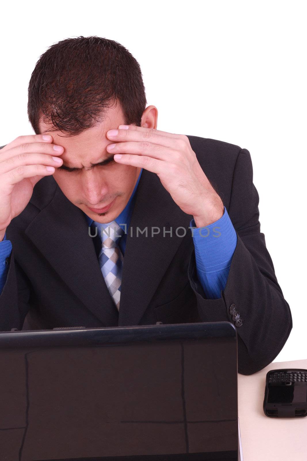 Image of businessman touching his head while looking at monitor with tired expression