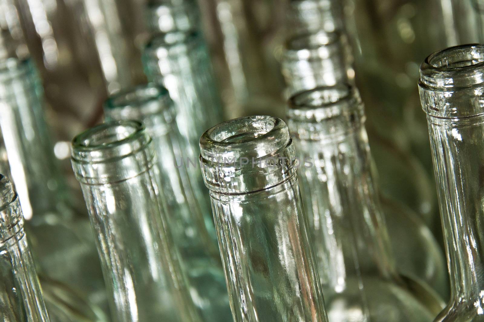 Close up of clear galss wine bottles waiting to be filled