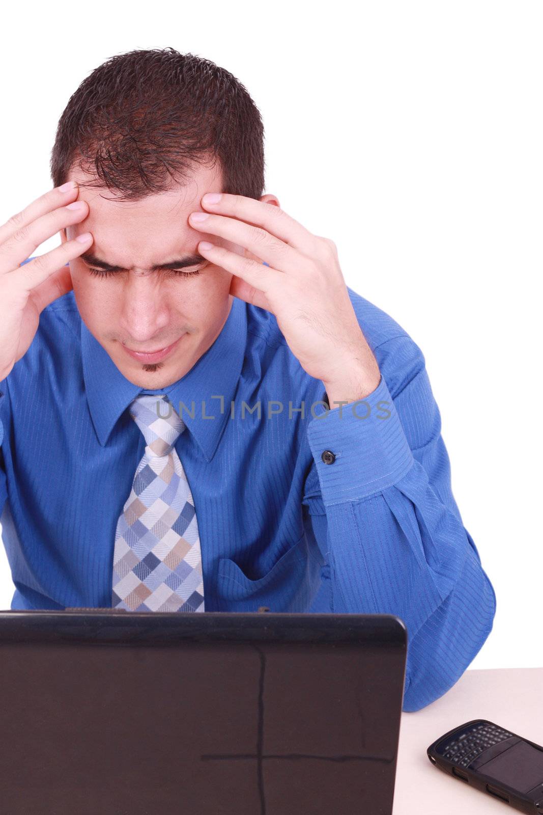 male frustrated with work sitting in front of a laptop.