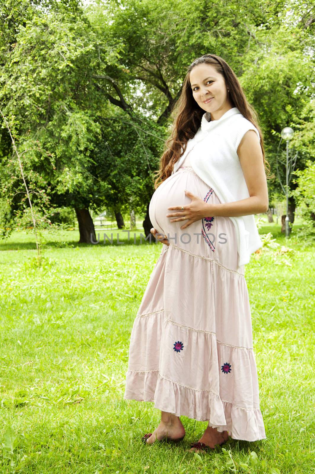 Pregnant Young Woman smile in summer park