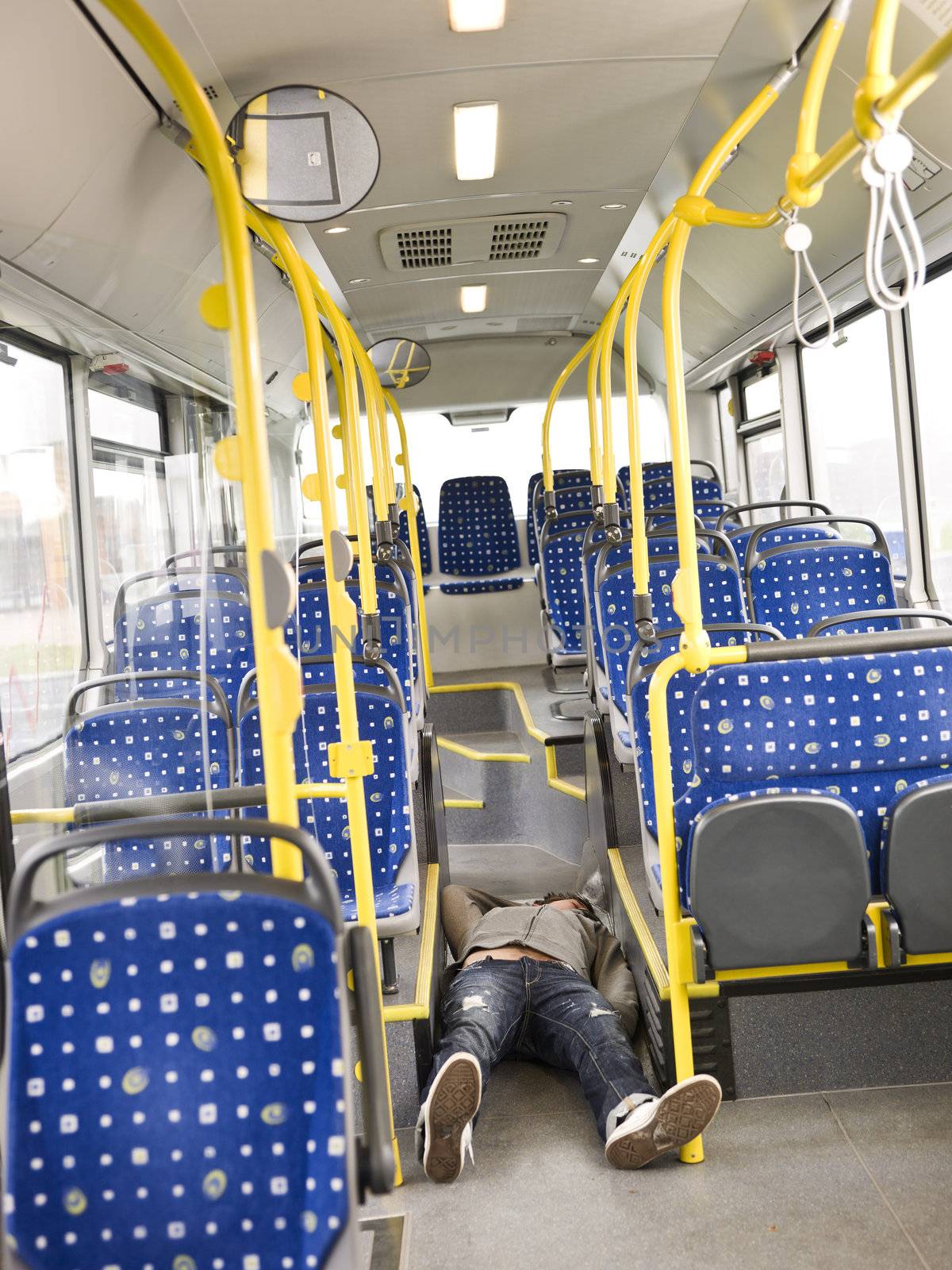 Young man lieing on the floor on the bus