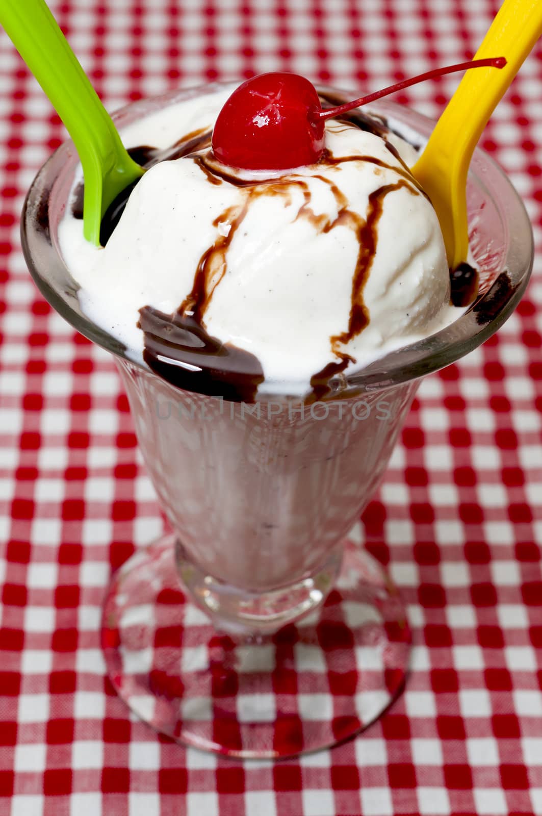 Vanilla Ice Cream and Spoons with Cherry and Chocolate Topping by dehooks