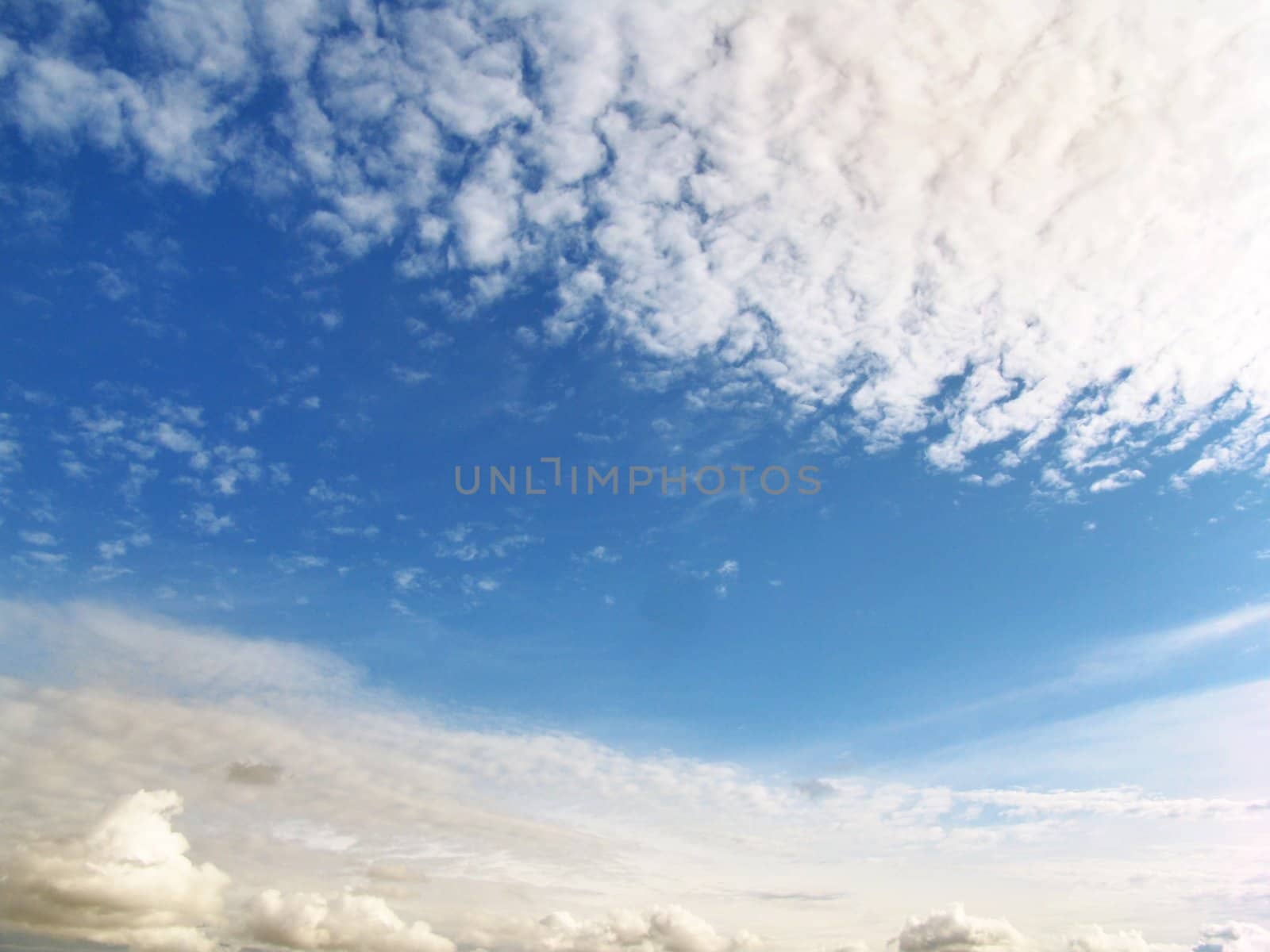 The blue sunny sky and beautiful white clouds
