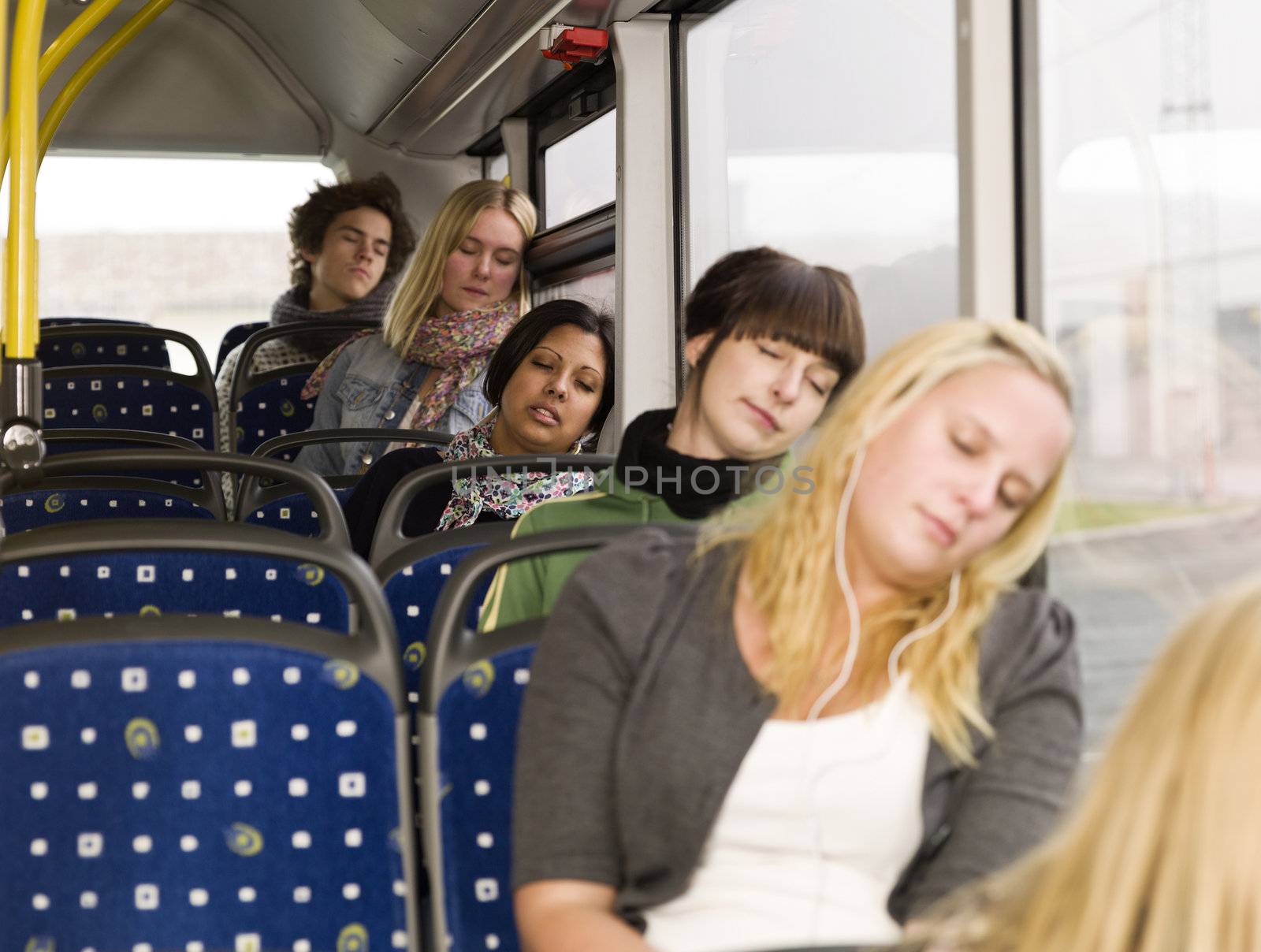 Group of young sleeping people on the bus