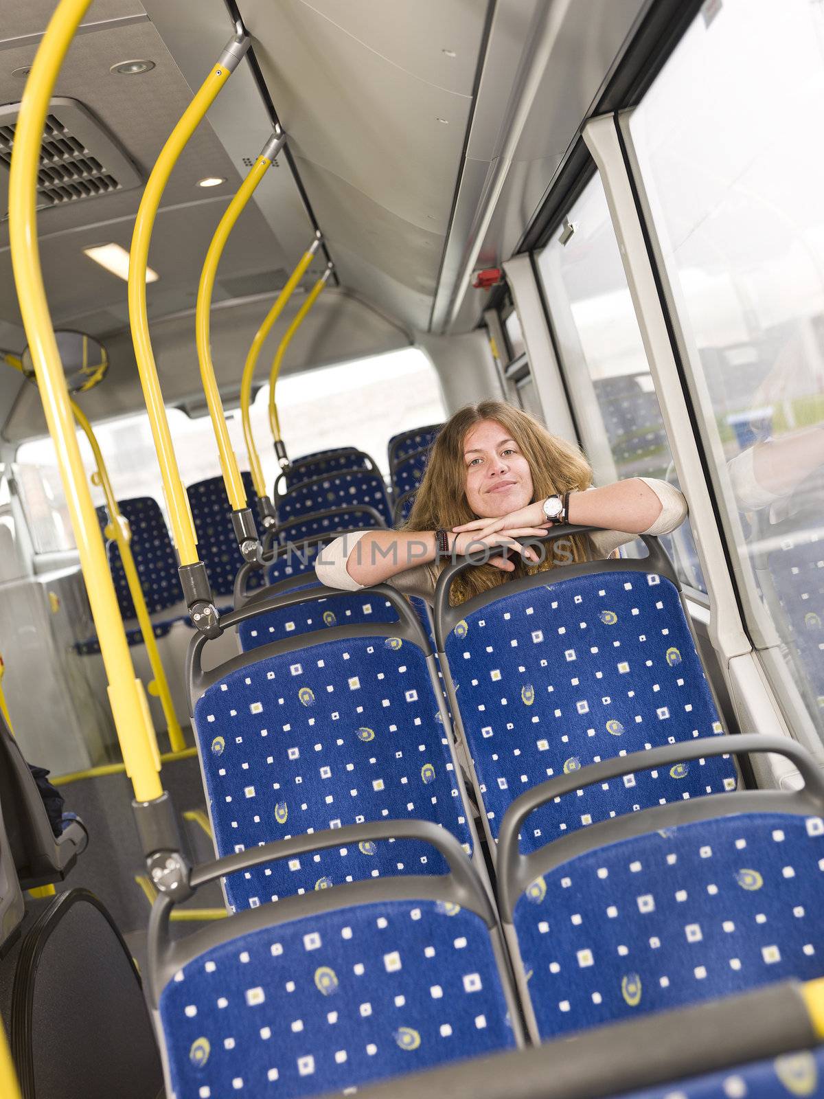 Young happy woman alone on the bus