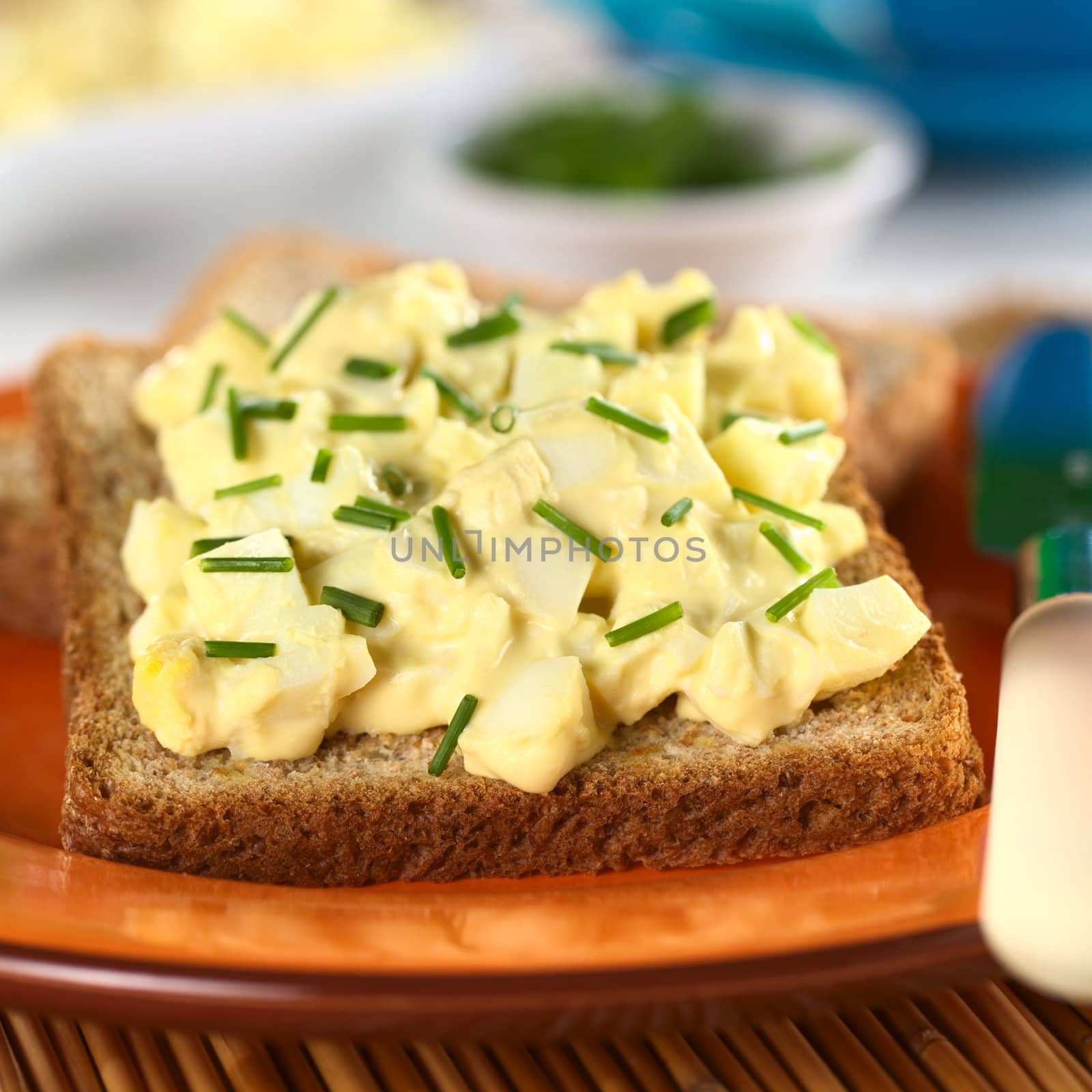 Egg salad with chives on wholewheat toast bread (Selective Focus, Focus on the front of the salad)