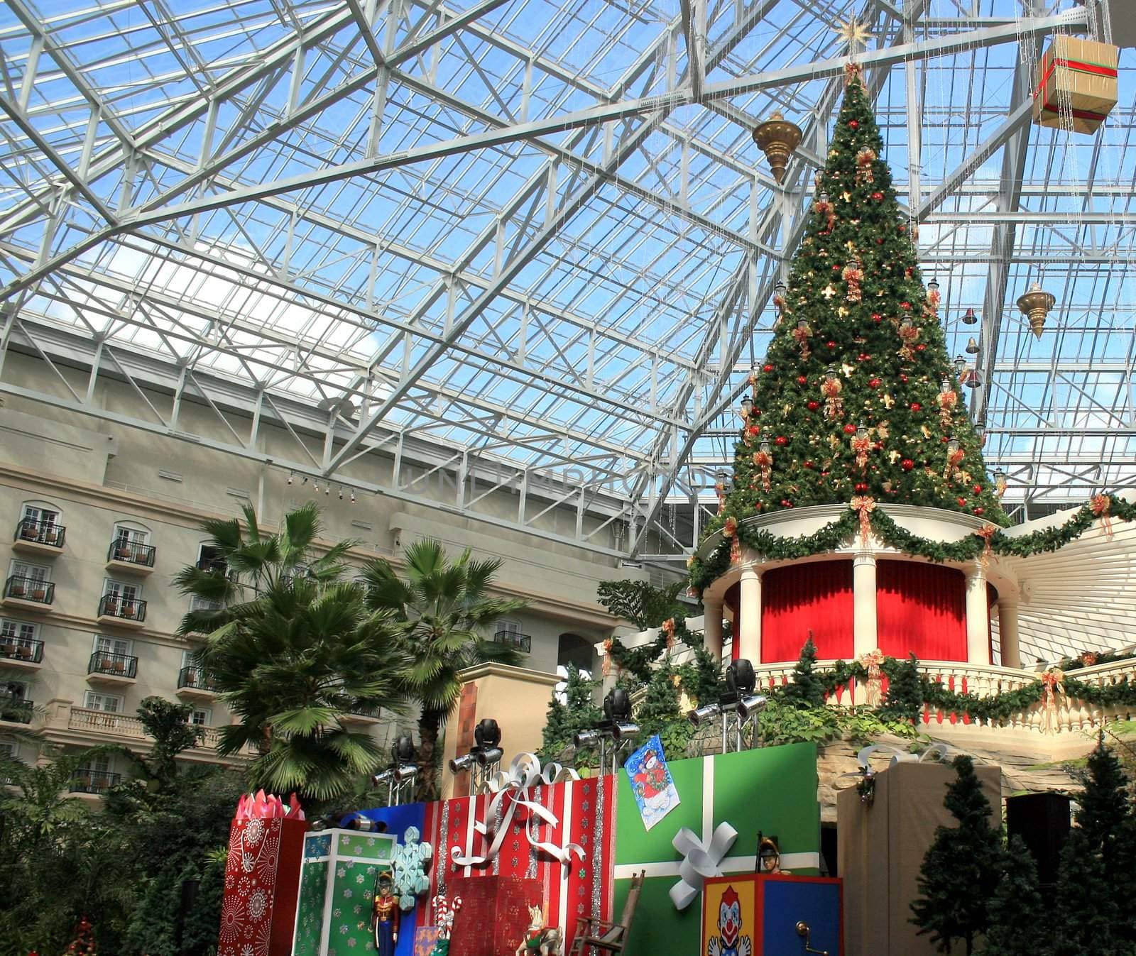 A large christmas tree, presents and decorations