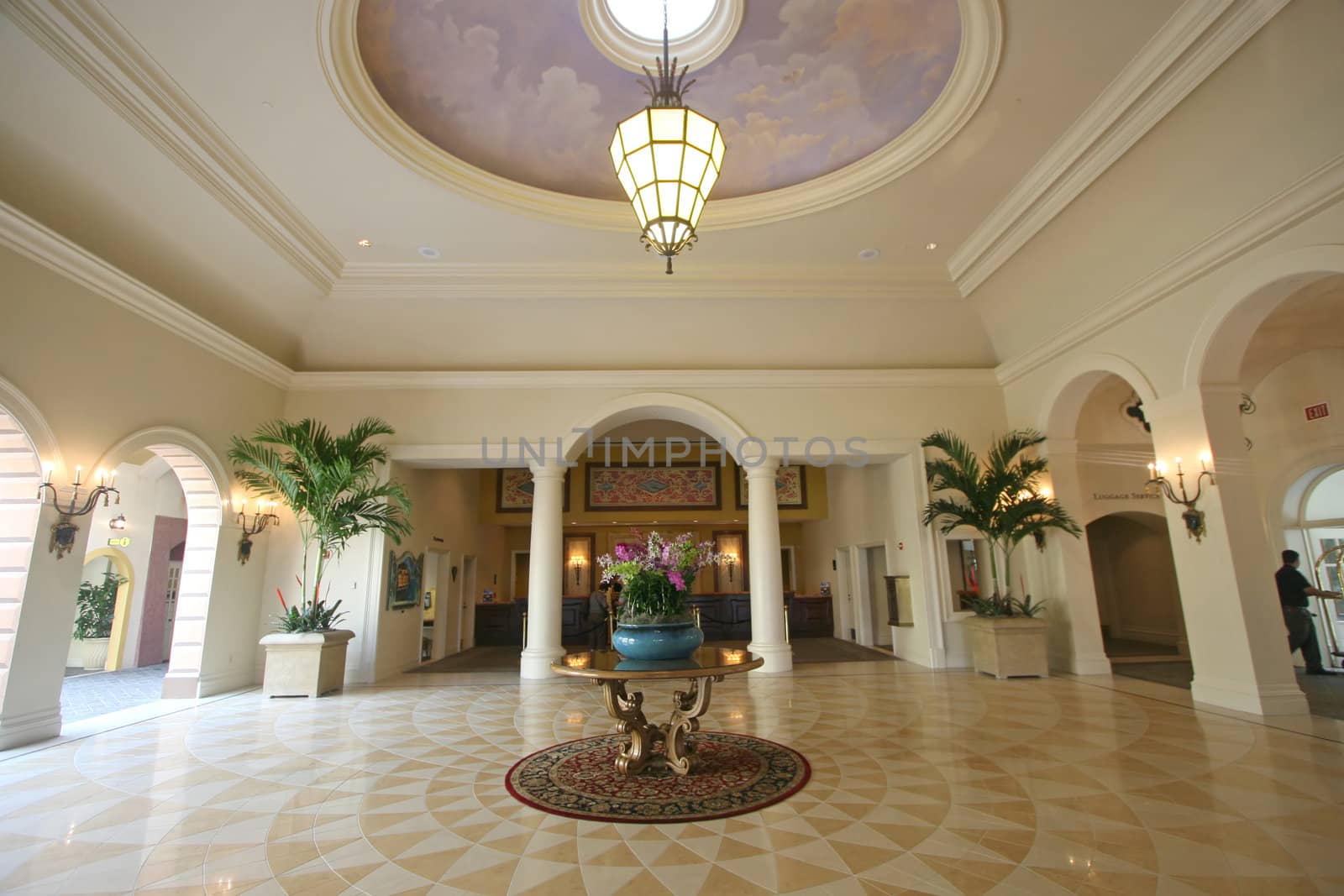 An interior of a hotel lobby with tile floor.