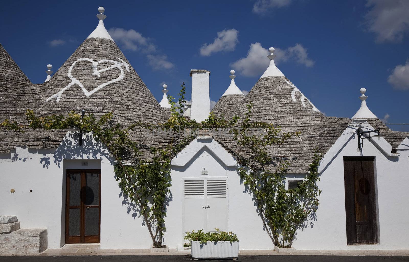 Urban Alberobello - Italy. A trullo is a traditional Apulian stone dwelling with a conical roof. The style of construction is specific to Itria Valley.