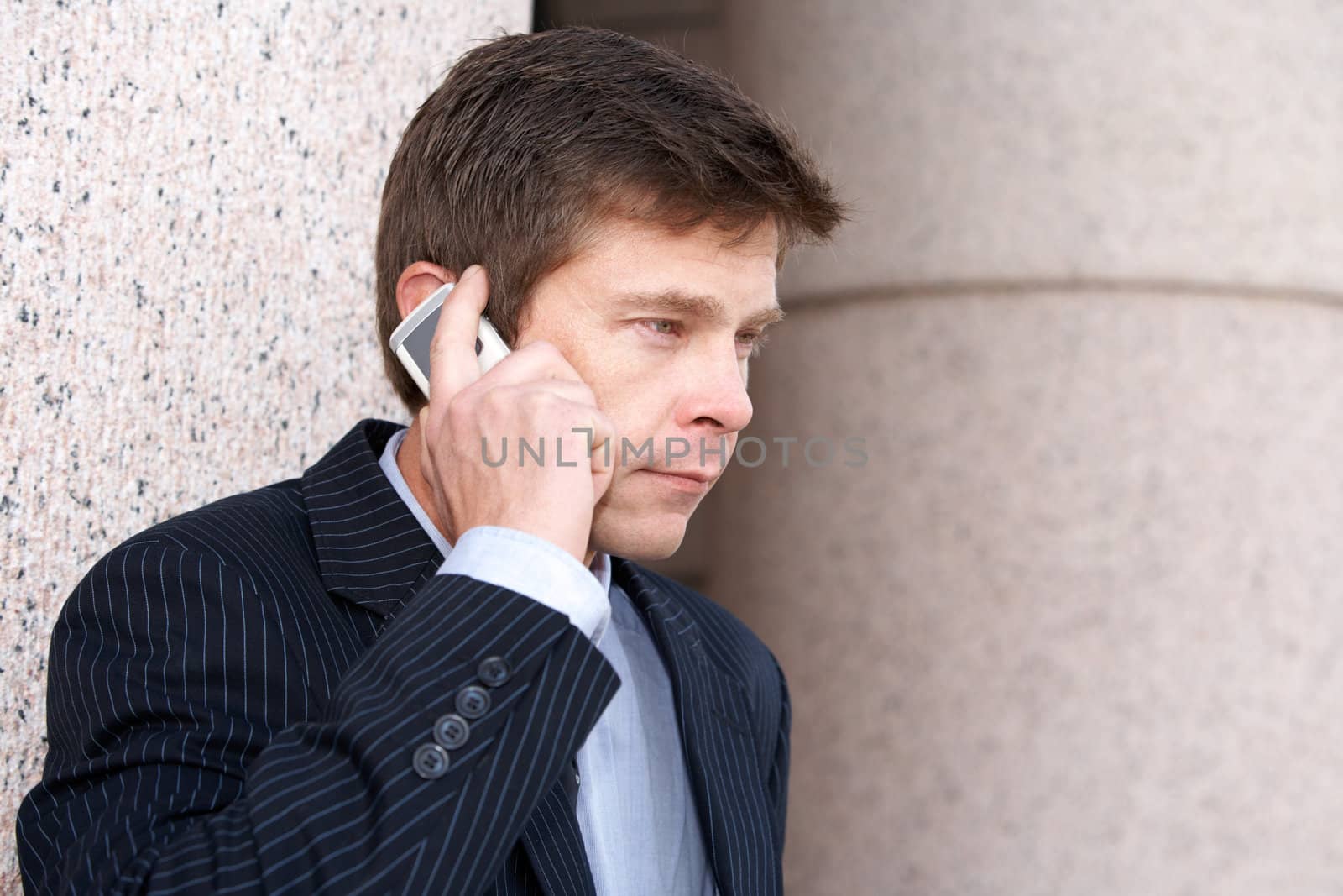 Man using cell phone outside building