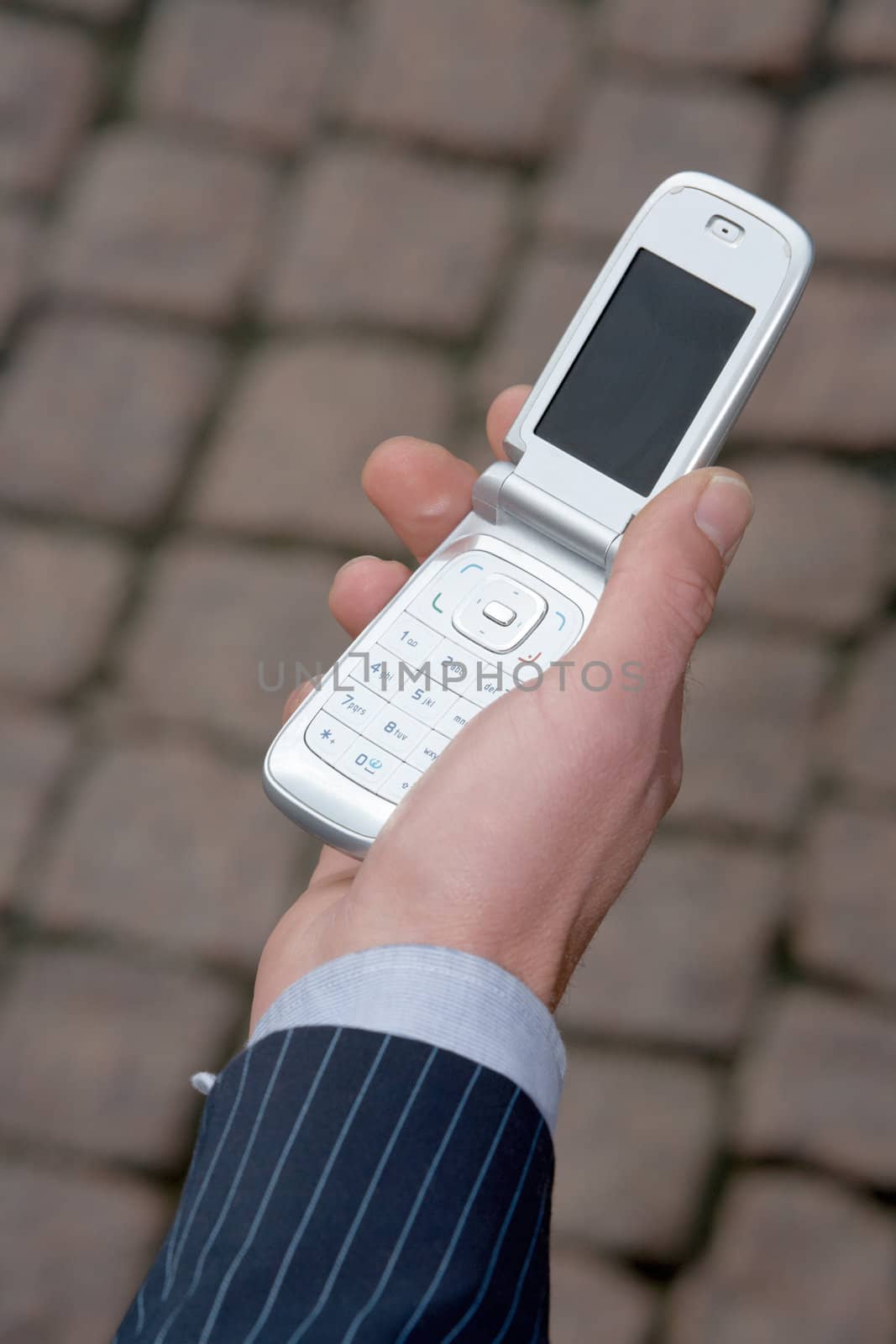 Holding cell phone by Luminis