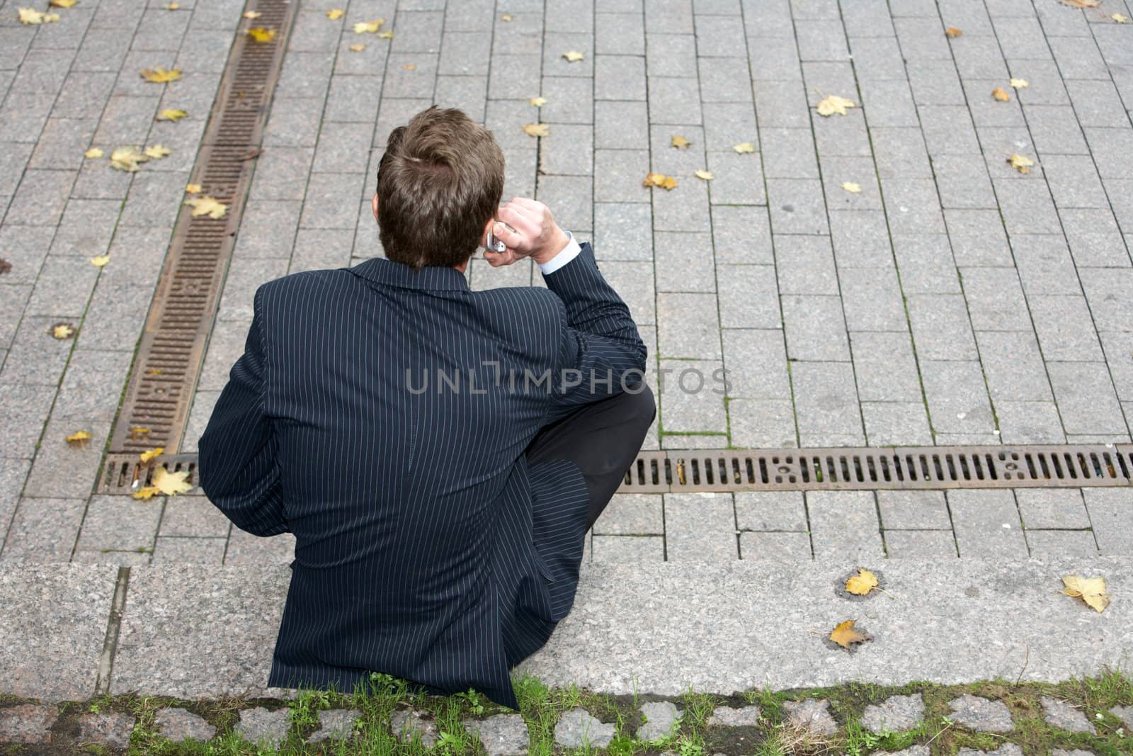 Man sitting alone, using cell phone