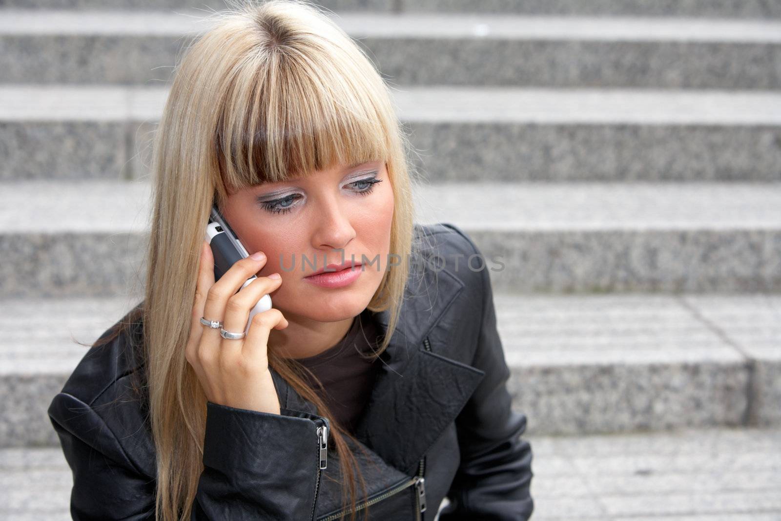 Young woman using mobile phone, looking down