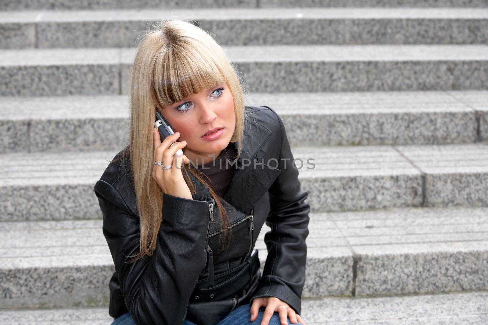 Young woman using mobile phone, looking away