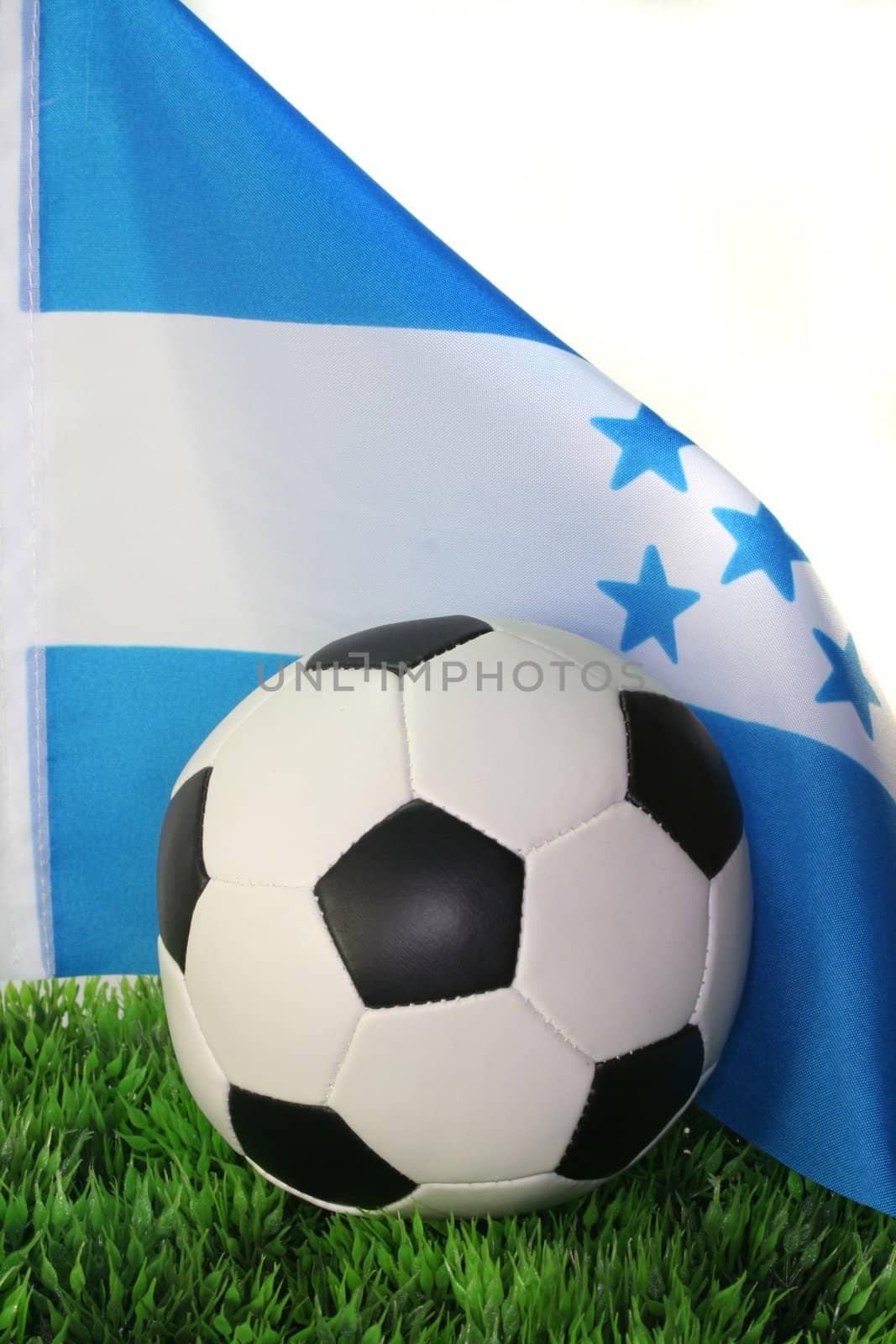 Flag of Honduras with soccer in a field