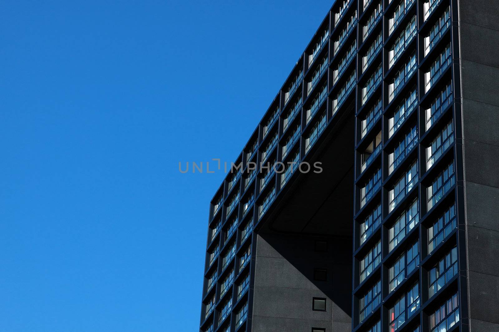 fragment of modern building over bright blue sky