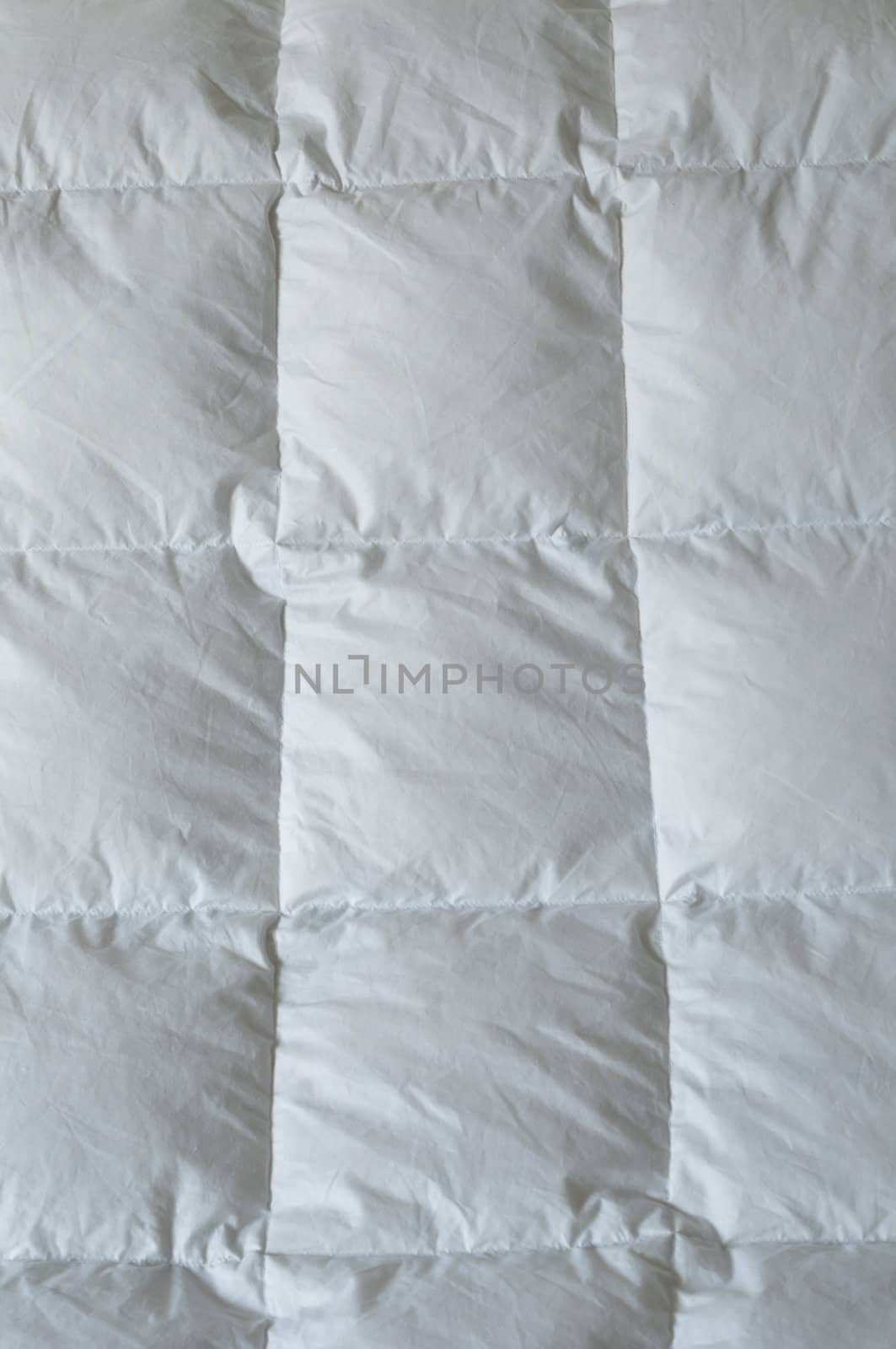 Detail of down comforter with white squares