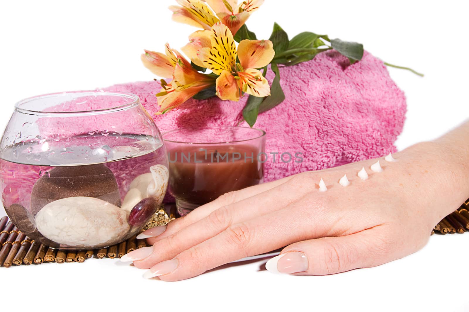 Woman hand with manicure and cream on spa treatment