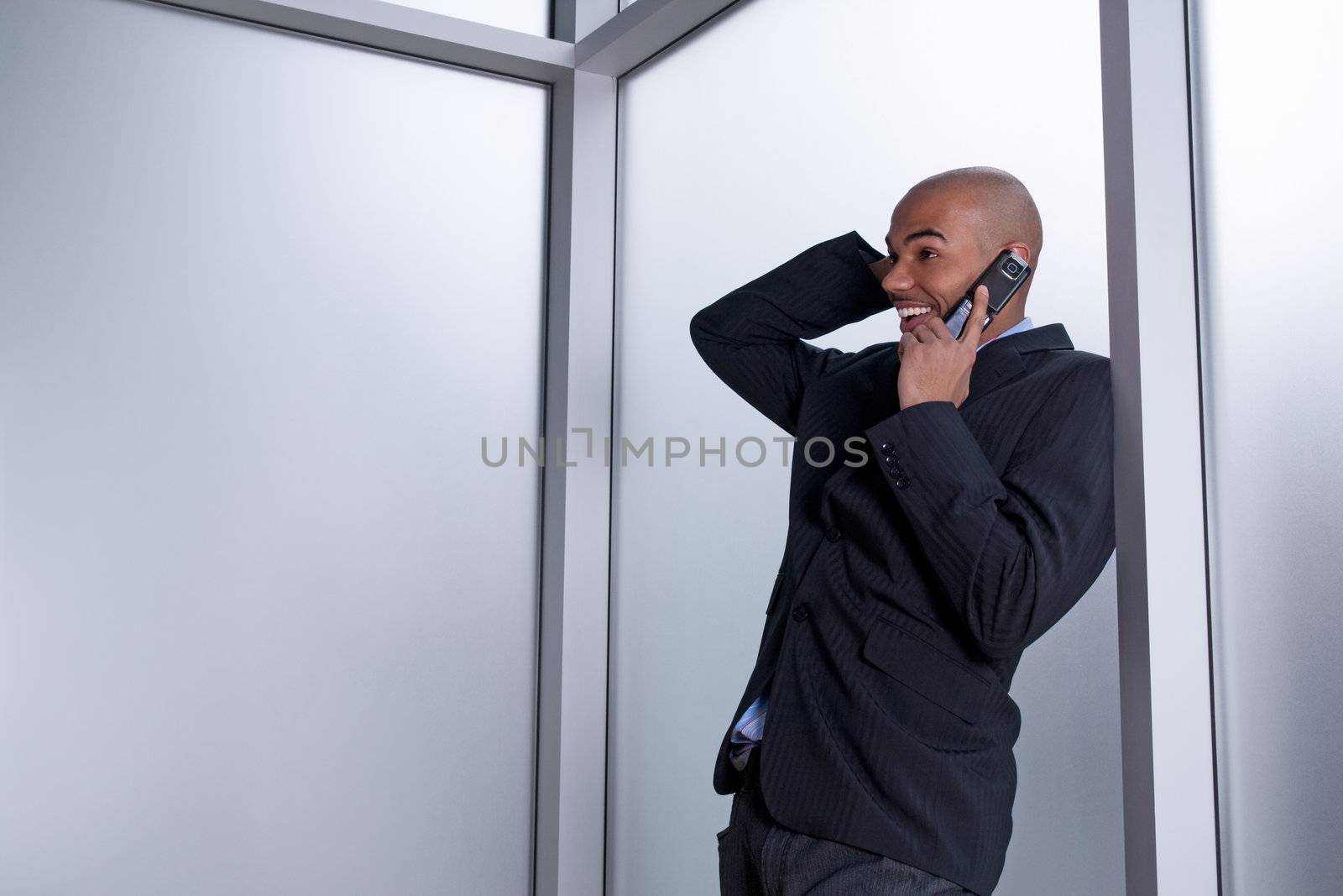 Expressive businessman talking on his cell phone, happy and excited.