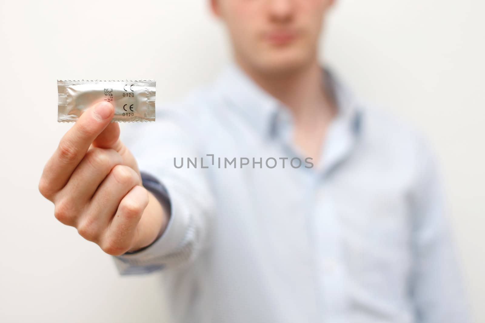 A man showing a condom