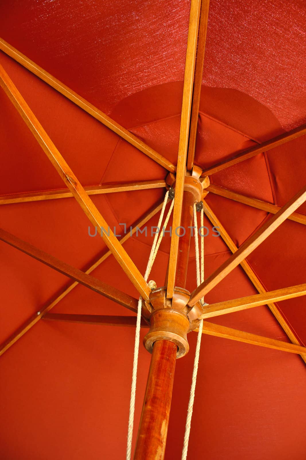 Under a red bamboo umbrella