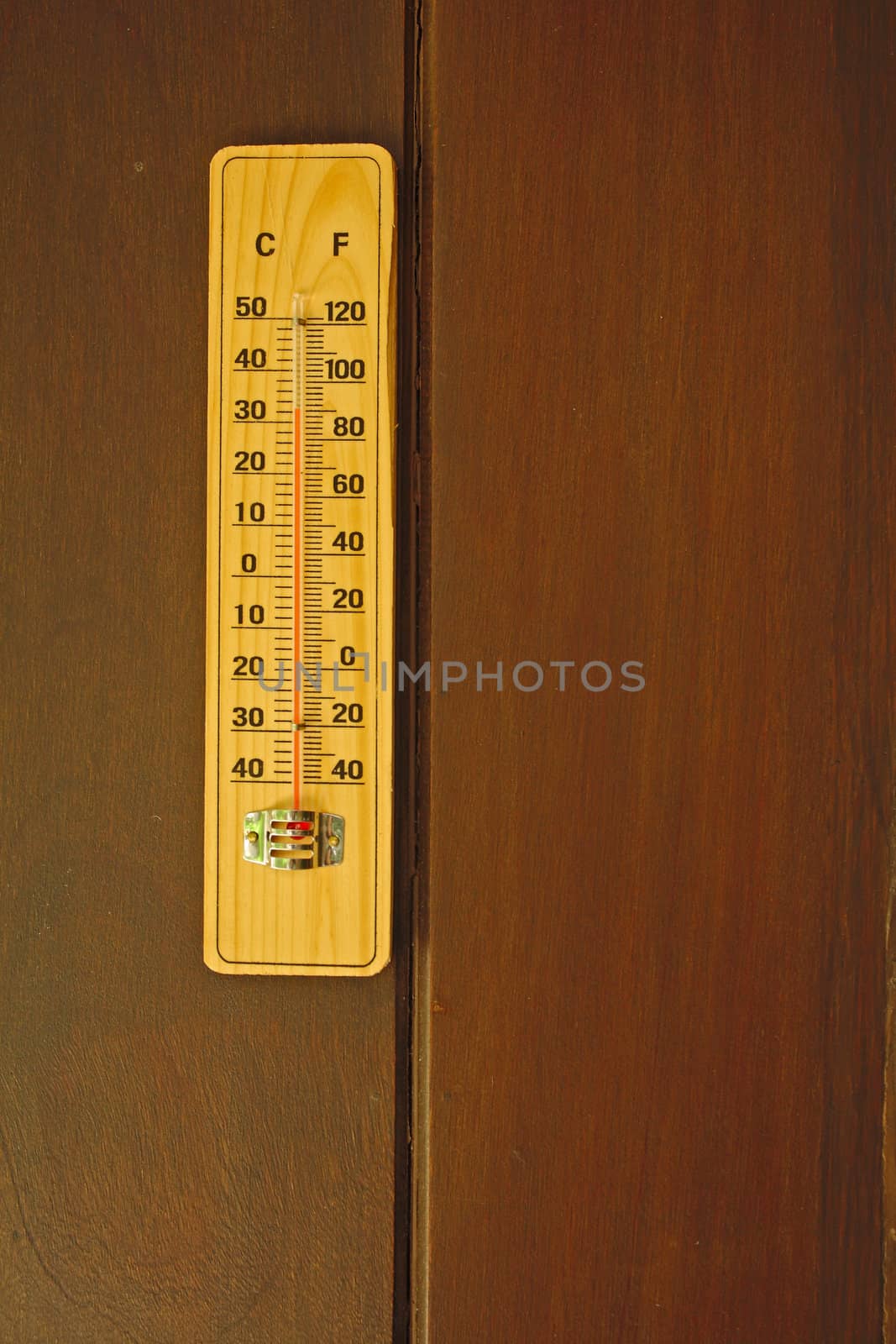 Thermometer isolated on wood background