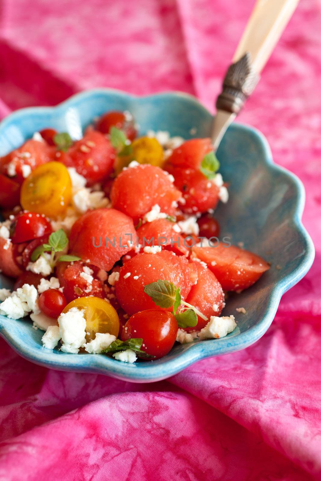 Beautiful and colorful watermelon salad with feta, tomatoes and mint